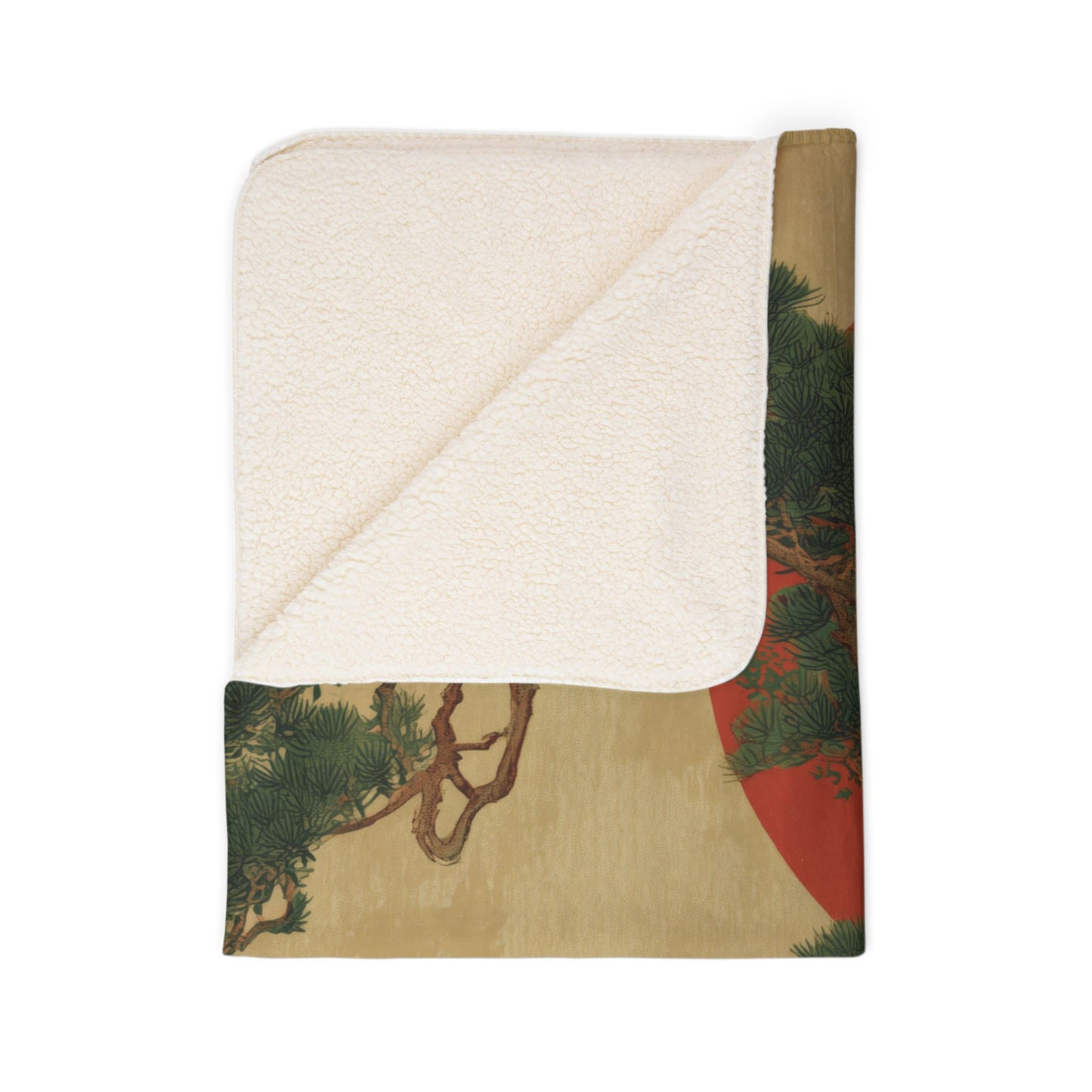 Folded blanket with nature-themed design on a white background