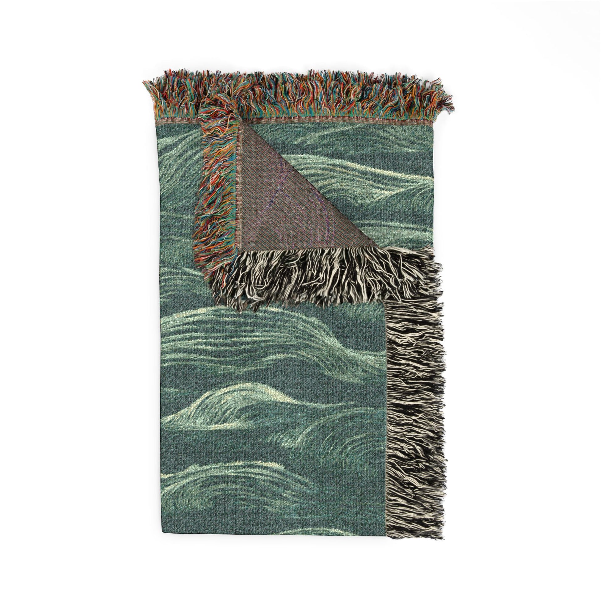 Green woven blanket with wavy pattern and fringed edges on a white background