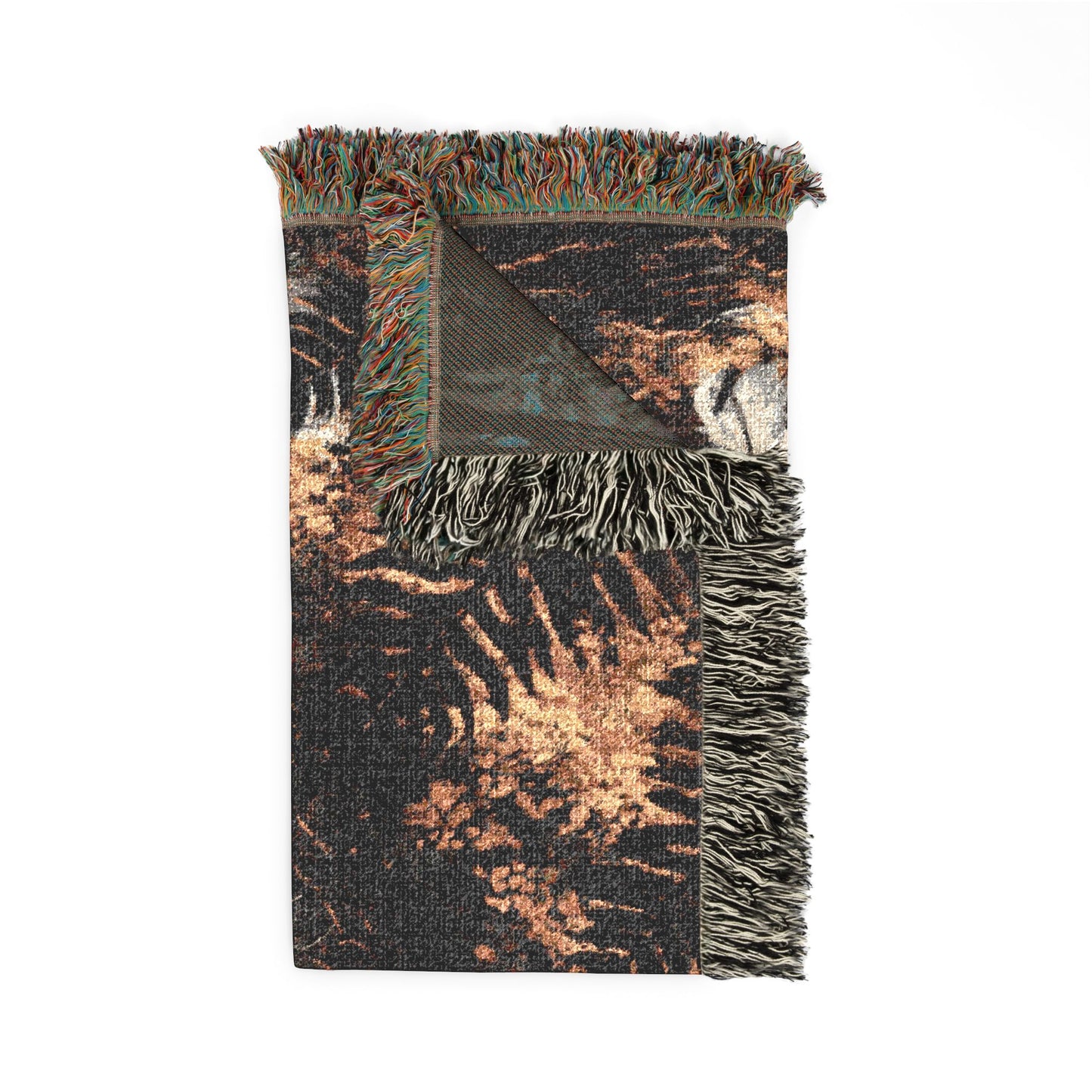 A folded woven throw blanket with multicolor fringe, featuring a distressed abstract pattern in black, brown, and beige tones, shown on a plain white background.