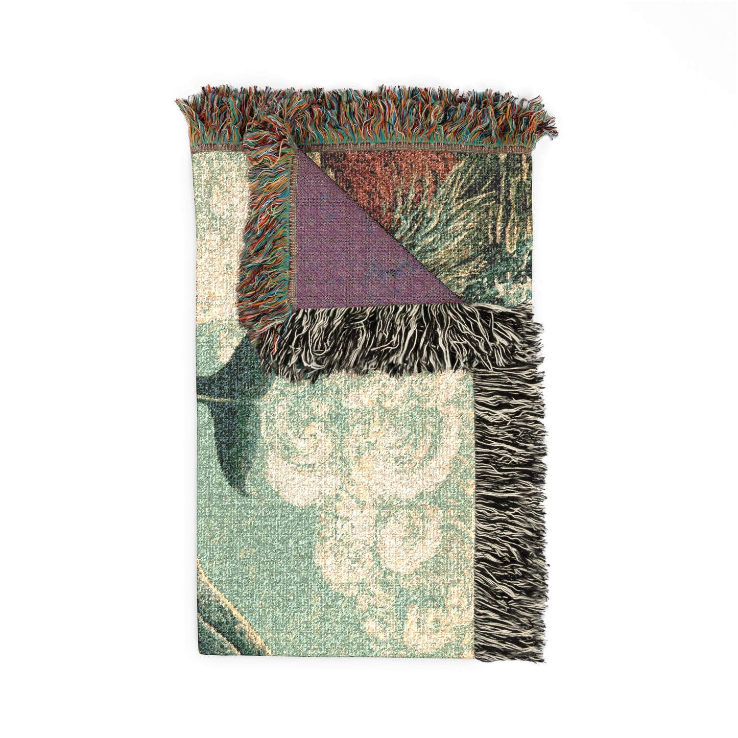 A folded woven throw blanket with fringe, featuring a muted green and cream damask pattern, a purple triangular corner, and multicolored fringe.