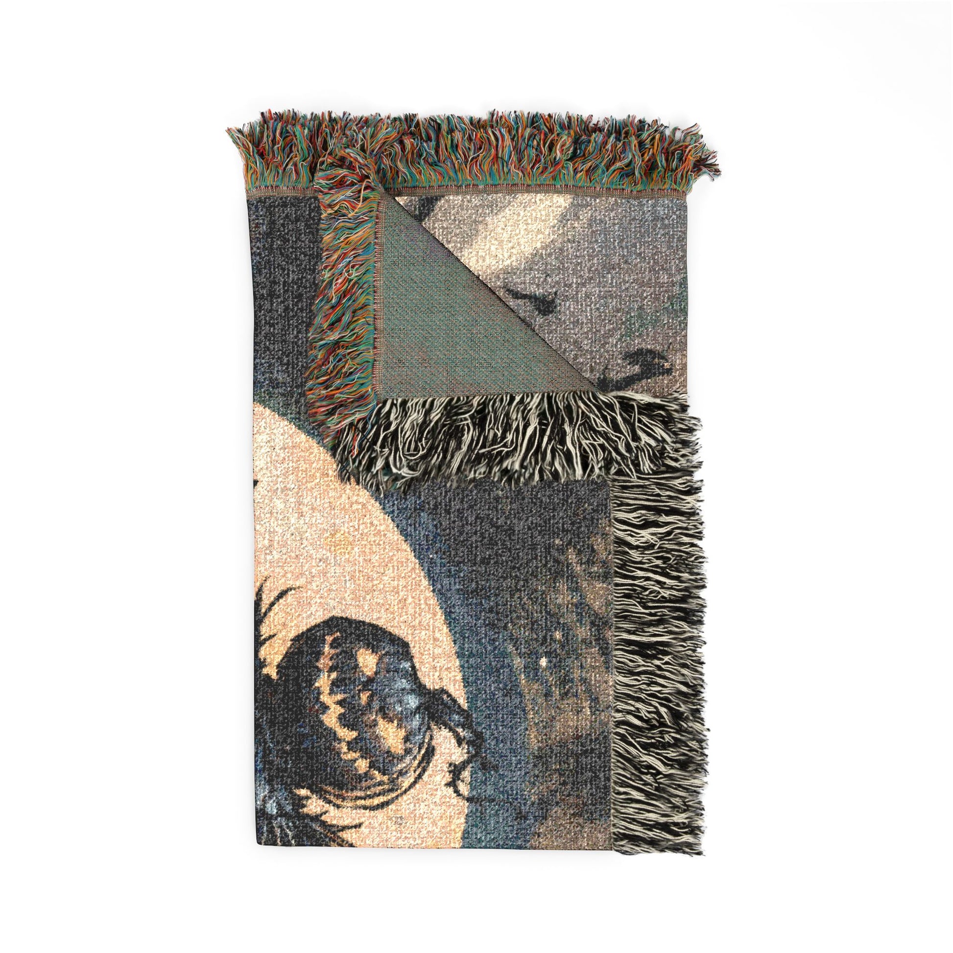 A rectangular woven throw blanket with fringed edges, featuring an abstract and graphic pattern in muted tones of gray, beige, green, and black.