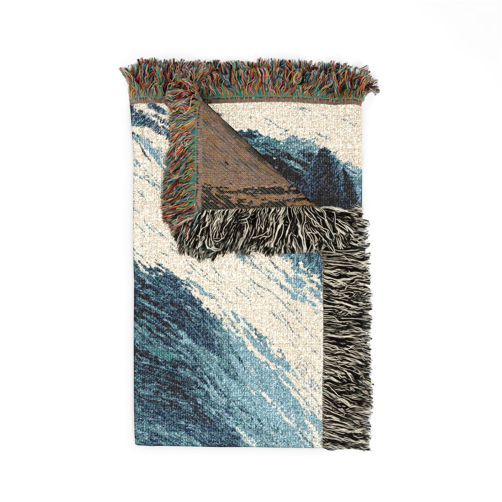 A rectangular woven throw blanket with multicolored fringe, featuring a wave-like pattern in shades of blue, beige, and brown, shown against a plain white background.