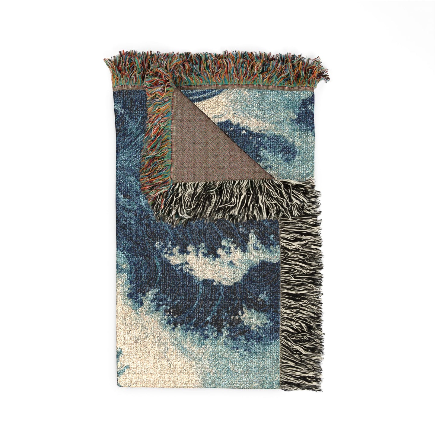 A rectangular woven throw blanket with a blue and beige ocean wave pattern, featuring multicolor fringe on the top and sides and a brown reverse side, shown on a plain white background.
