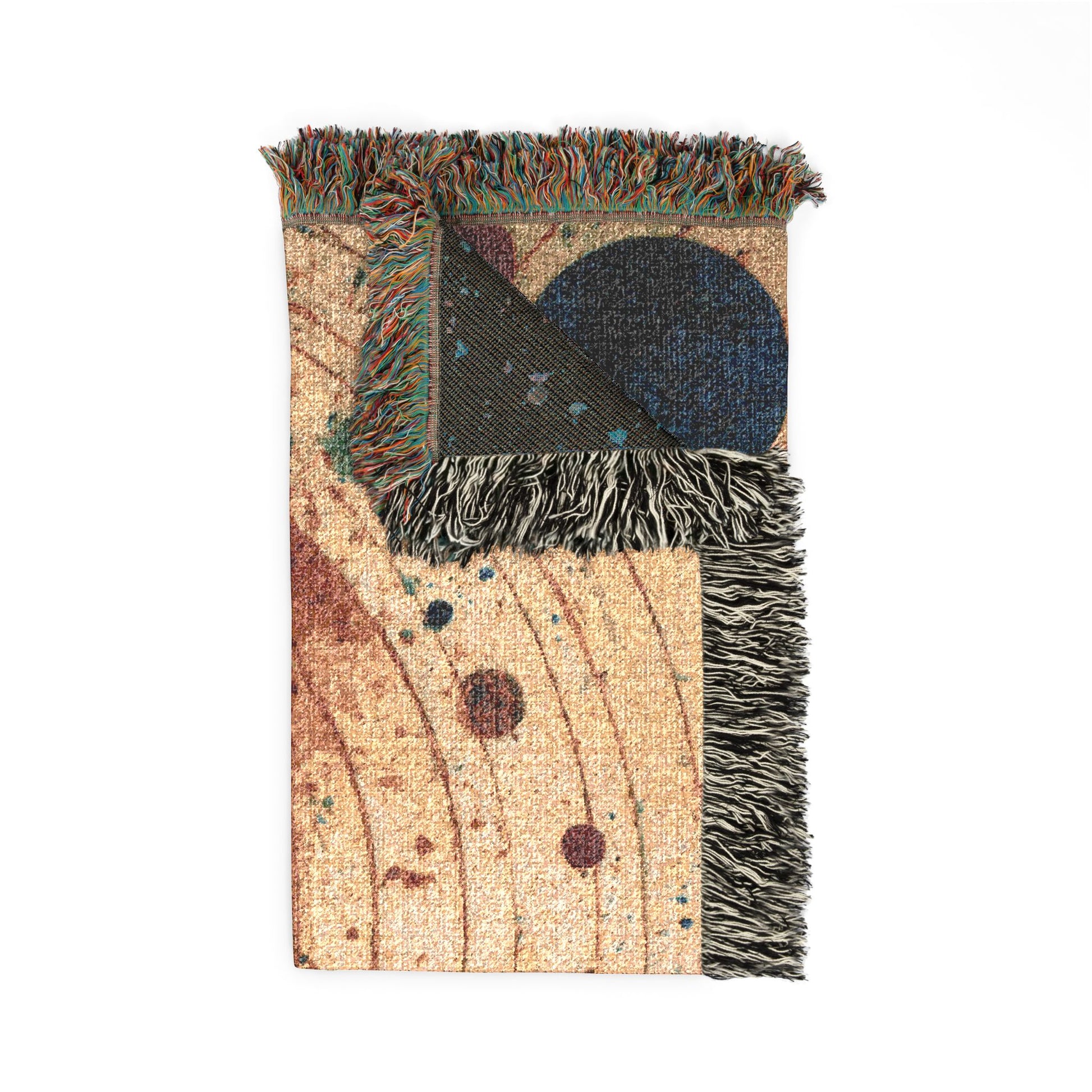 A rectangular woven throw blanket with fringe, featuring a celestial pattern with a beige background, brown curved lines, and dark blue and black circular motifs, shown on a plain white background.