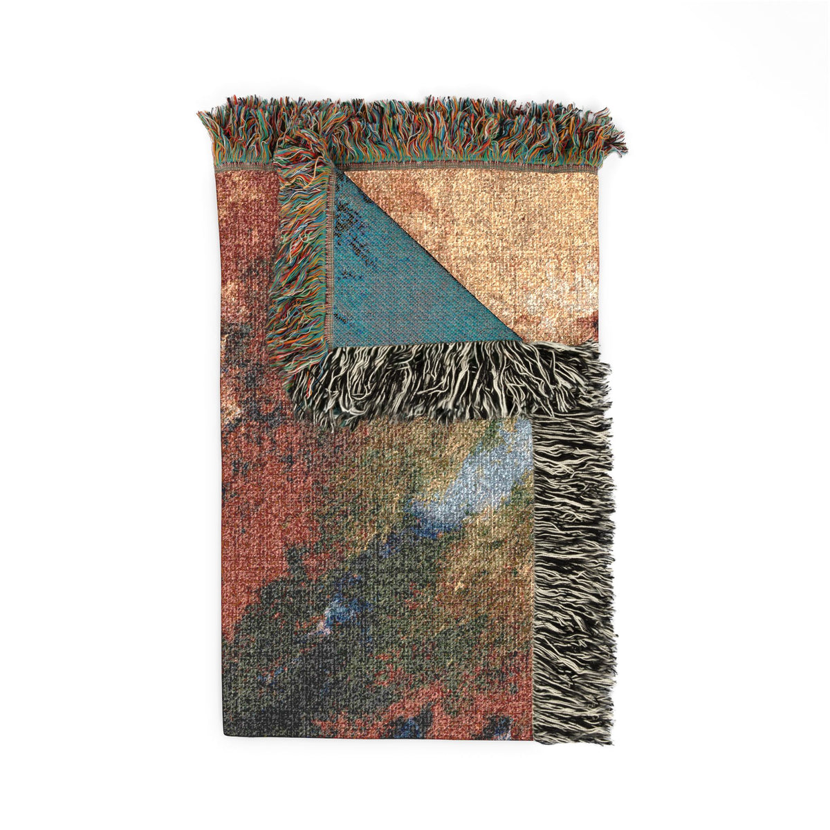 A folded woven throw blanket with fringed edges, featuring a multicolor abstract pattern in rust red, teal, beige, and dark gray on a white background.