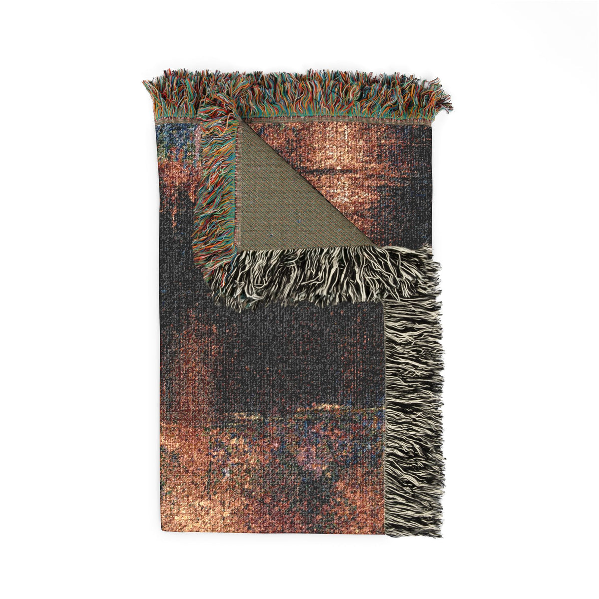 A folded woven throw blanket with multicolor distressed copper, brown, black, and teal tones, featuring fringed edges and a textured surface, shown on a plain white background.
