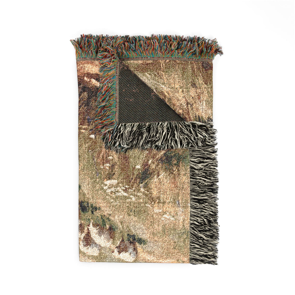 A rectangular woven throw blanket with a multicolor abstract landscape pattern in earthy tones, featuring black and white fringed edges and a black reverse side, shown flat on a white background.