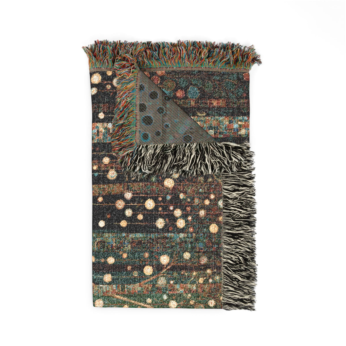 A rectangular woven throw blanket with fringed edges, featuring a dark charcoal base with a multicolor celestial pattern of stars and dots in teal, rust, beige, and brown, with a triangular patterned corner detail.