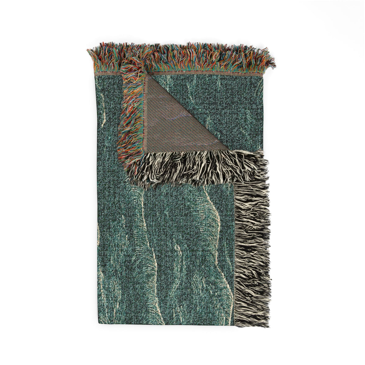 A rectangular woven throw blanket with fringe on two short ends, shown on a plain white background. The blanket has a textured abstract pattern in teal, green, beige, and brown, with one corner folded over to reveal the reverse side.
