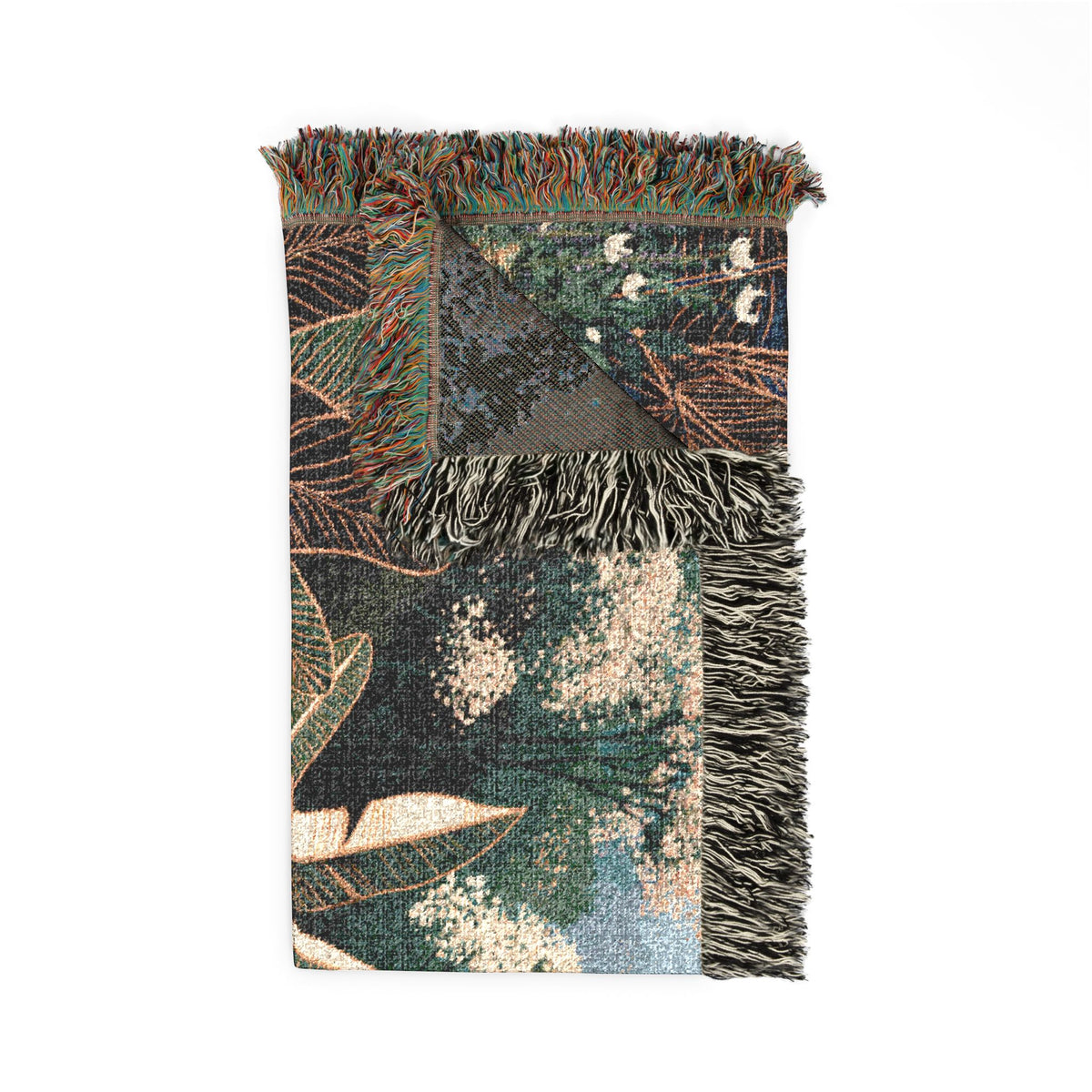 A rectangular woven throw blanket with fringed edges, featuring an abstract botanical pattern in dark green, beige, brown, and blue tones, shown flat against a white background.