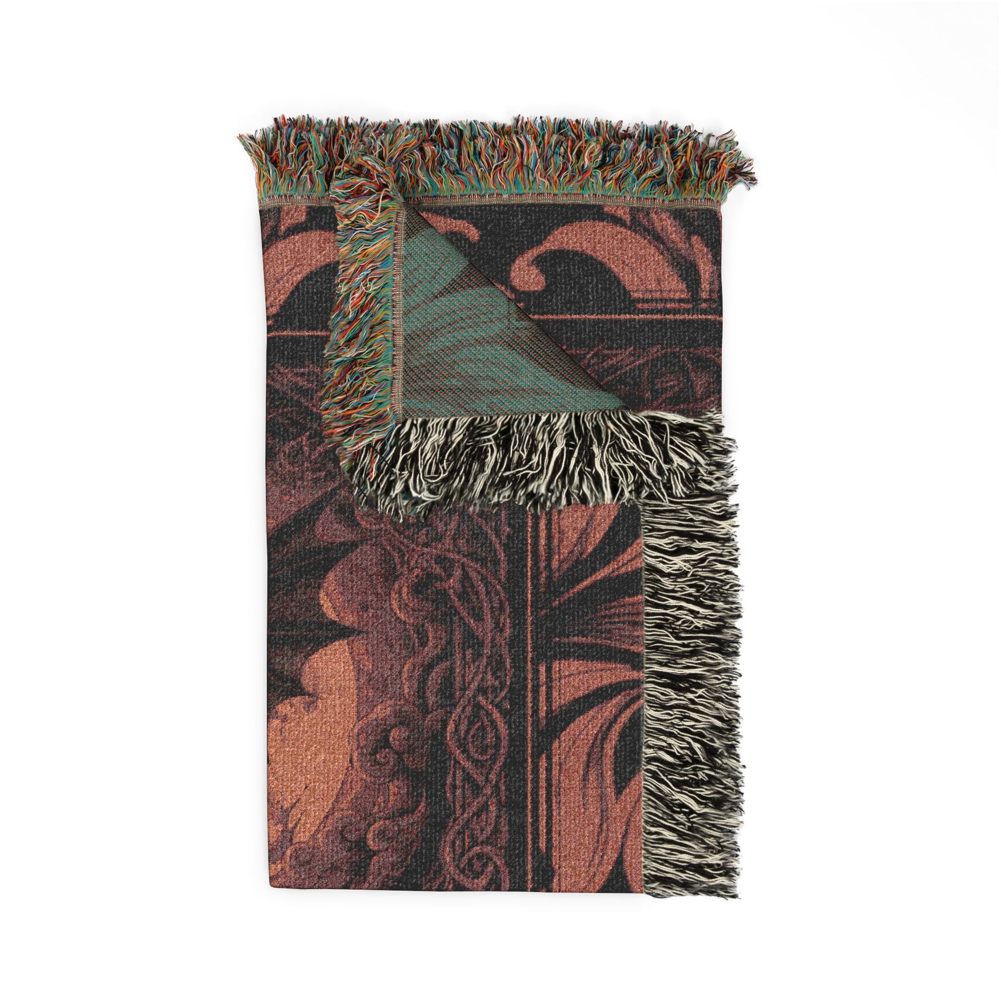Decorative throw blanket with intricate patterns and fringes on a white background