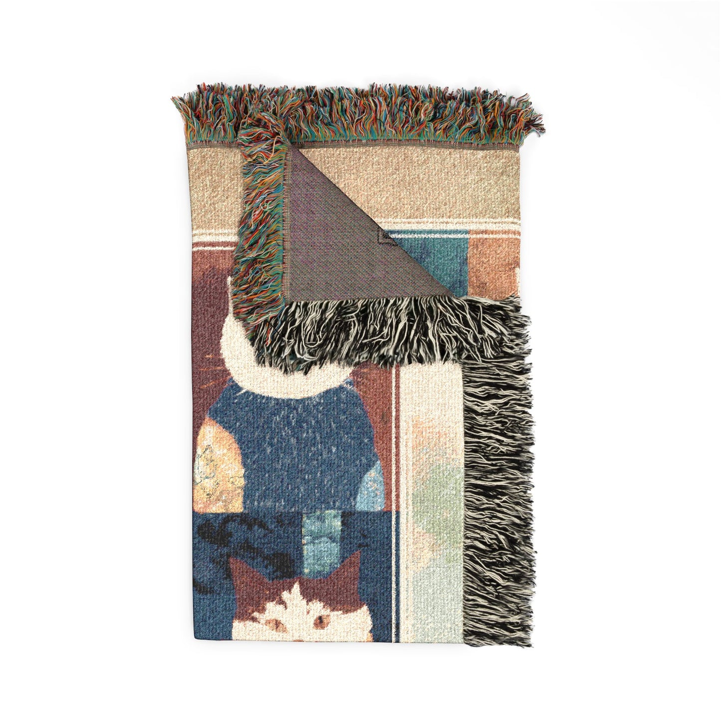 Multicolored woven blanket with fringe on a white background