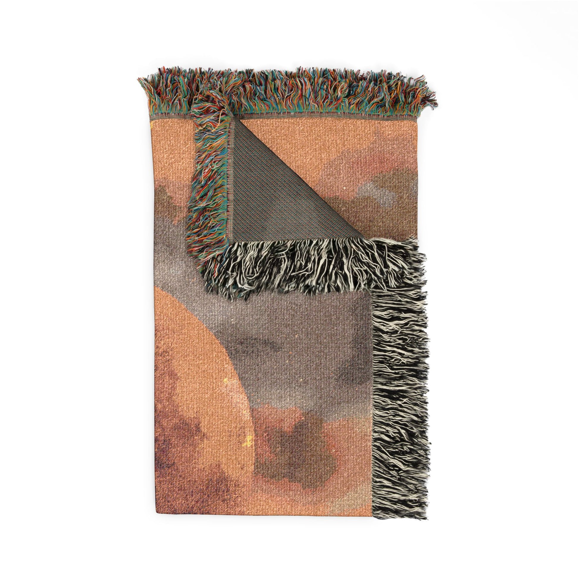 patterned blanket with fringed edges on a white background