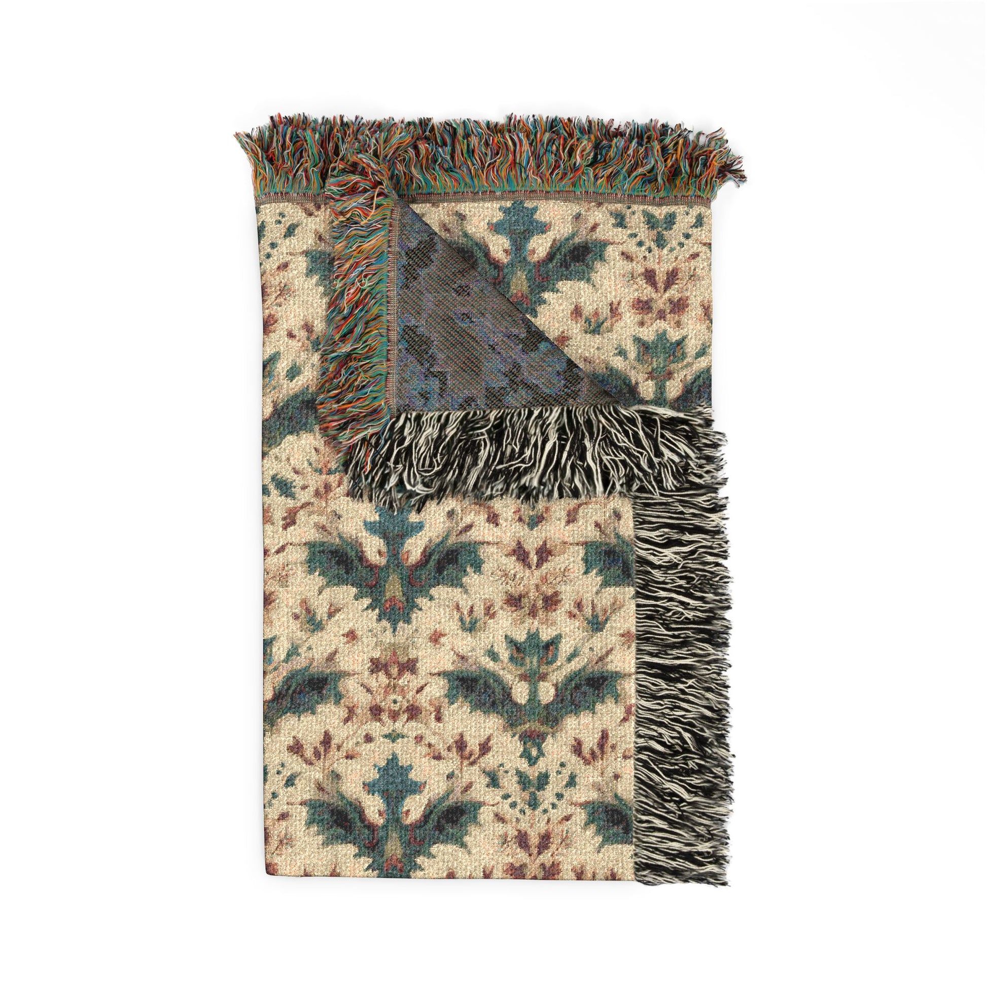 Decorative throw blanket with intricate pattern and fringes on a white background