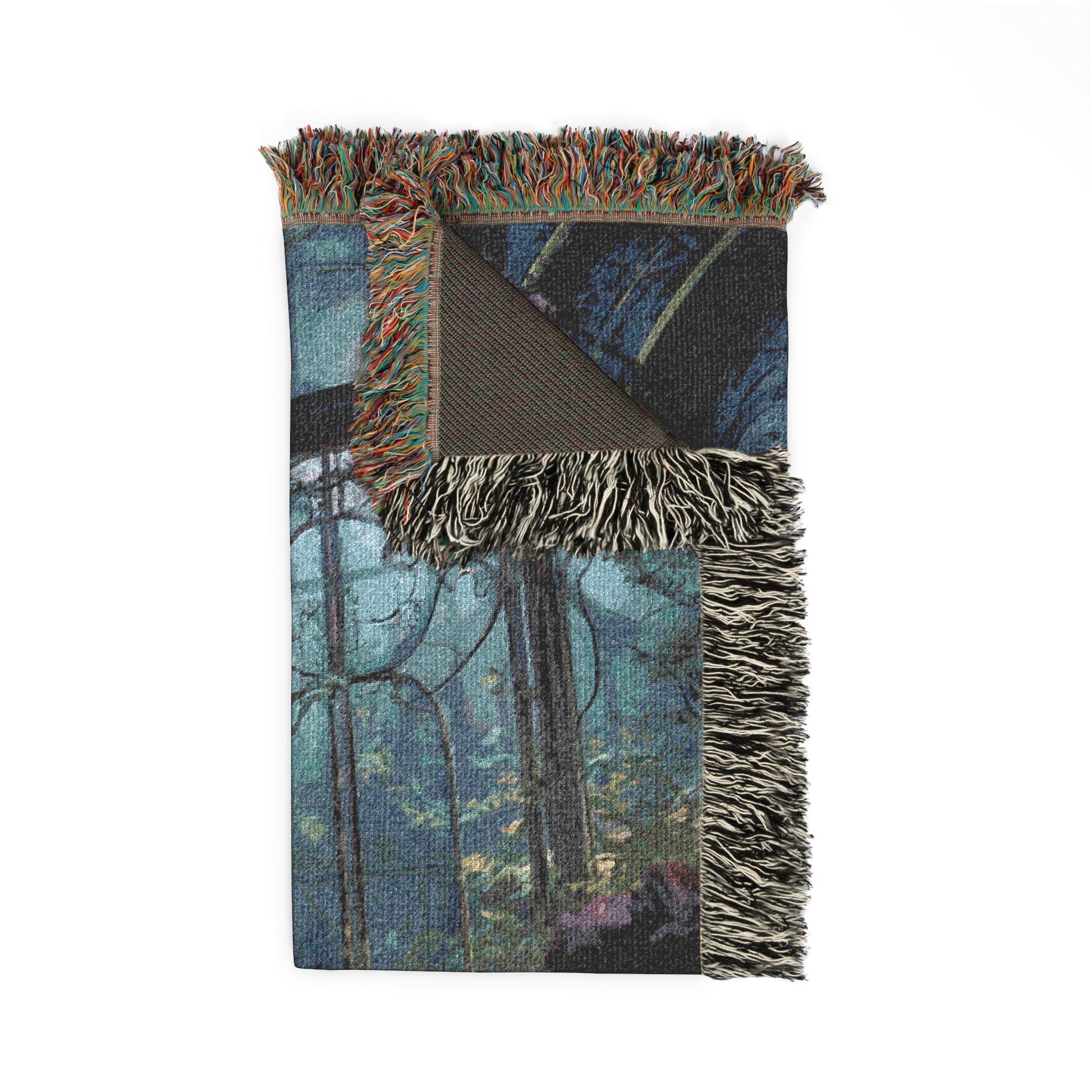 Woven blanket with forest design and fringed edge on a white background