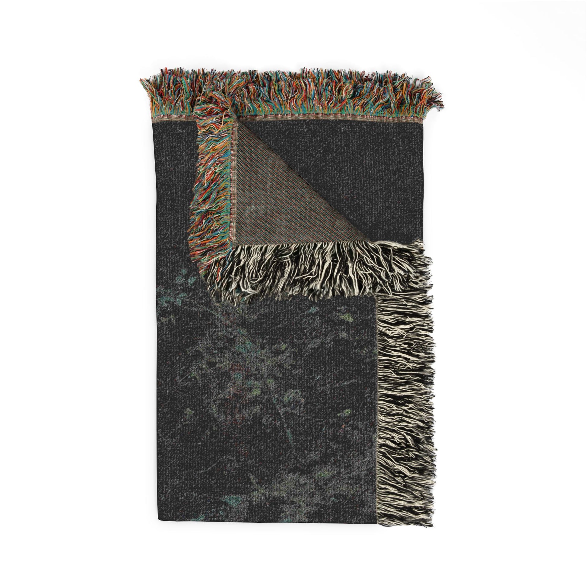 Black woven blanket with colorful fringe on a white background