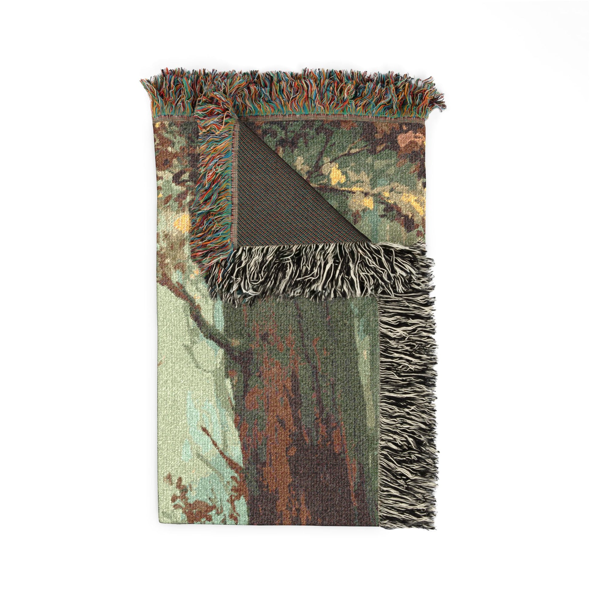 Camouflage-patterned blanket with fringed edges on a white background