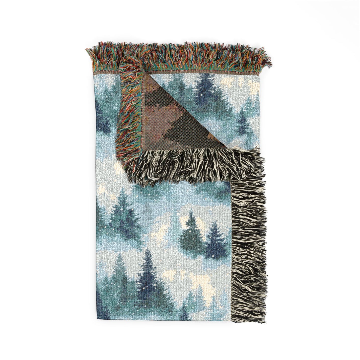Woven blanket with forest design and fringed edges on a white background