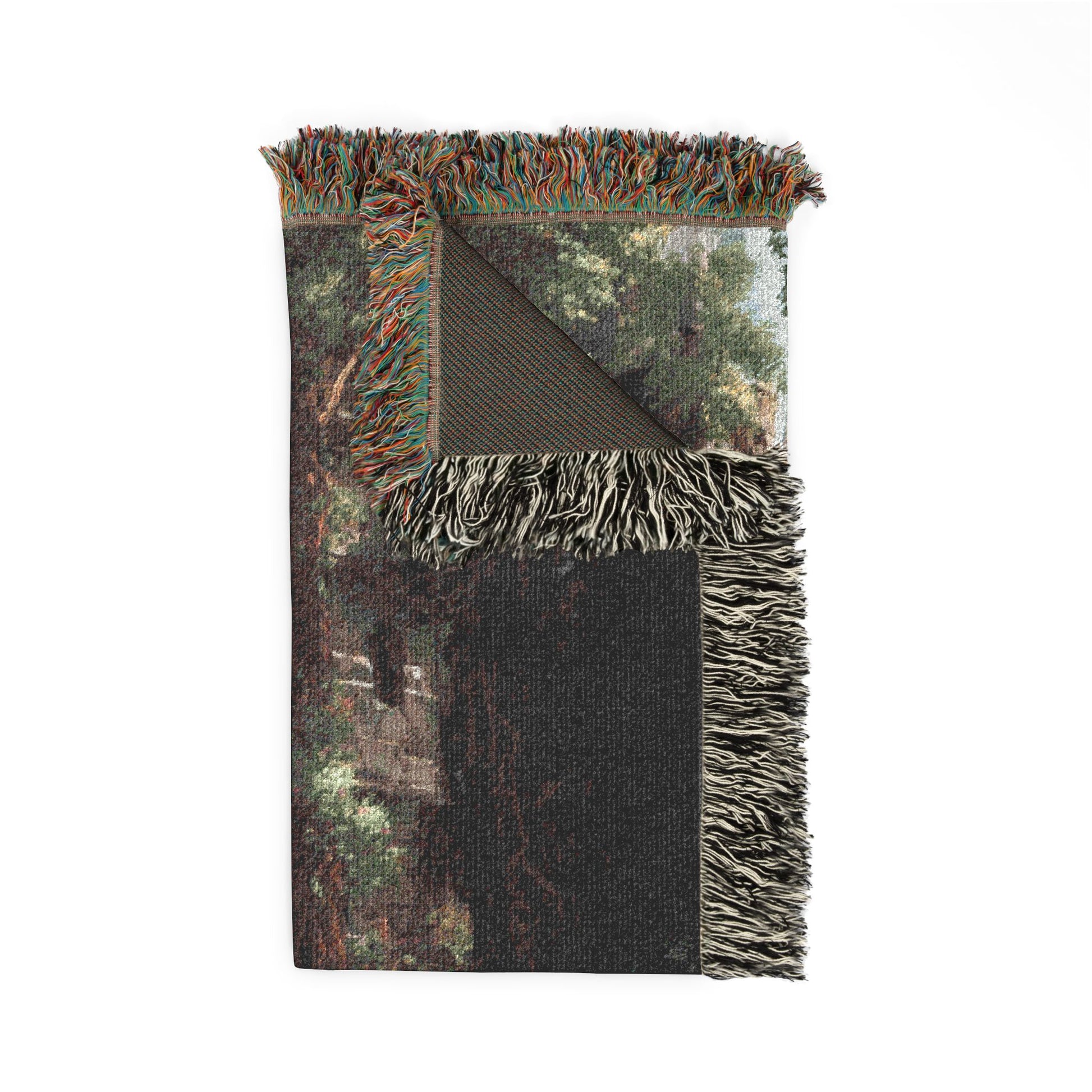 Camouflage-patterned blanket with fringed edges on a white background