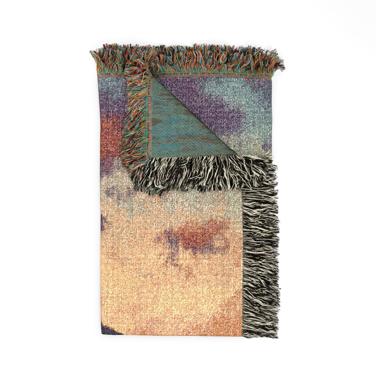 A folded woven throw blanket with multicolor abstract patterns in beige, purple, teal, and rust, finished with black and beige fringe on a white background.