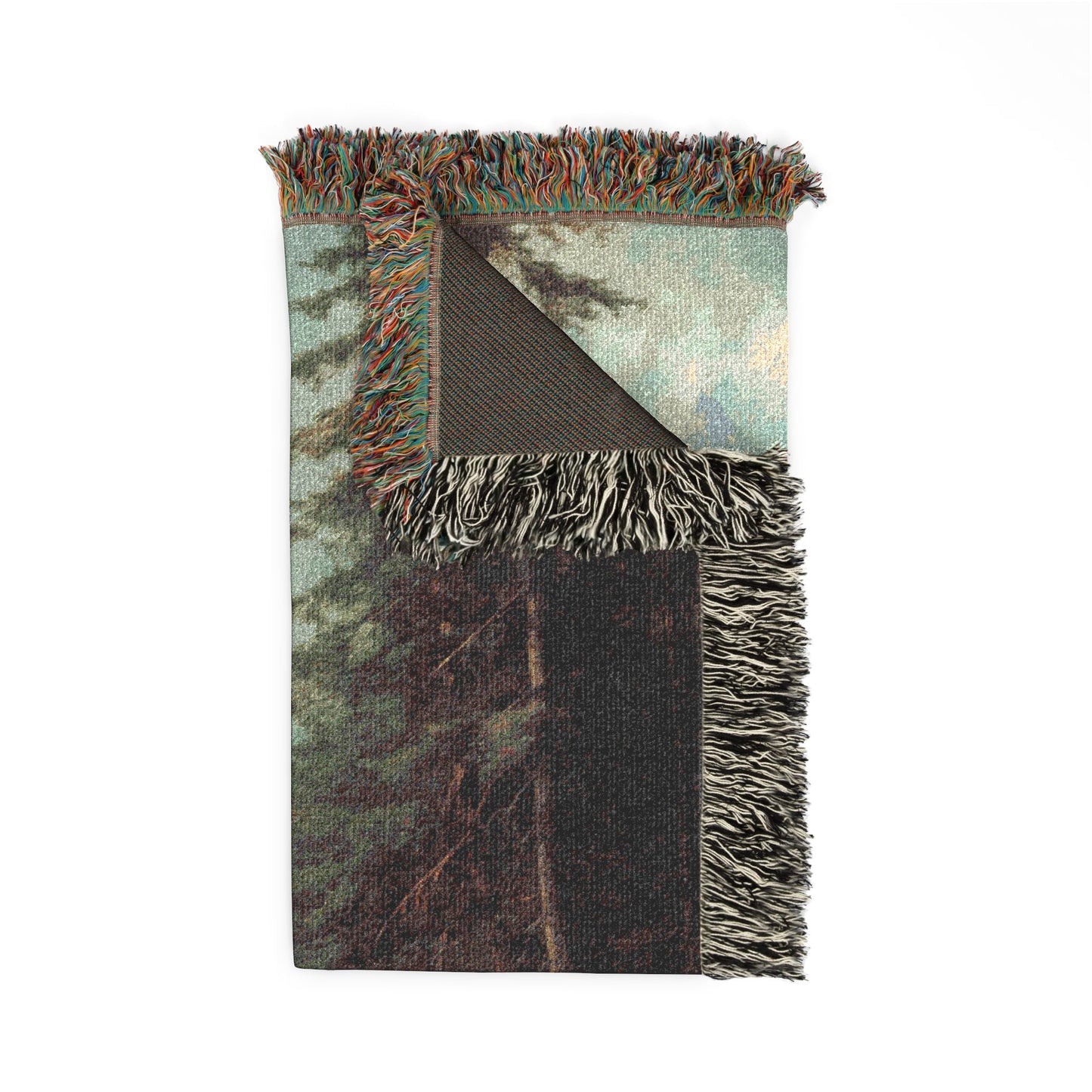 Woven blanket with fringed edges featuring a nature-themed design on a white background