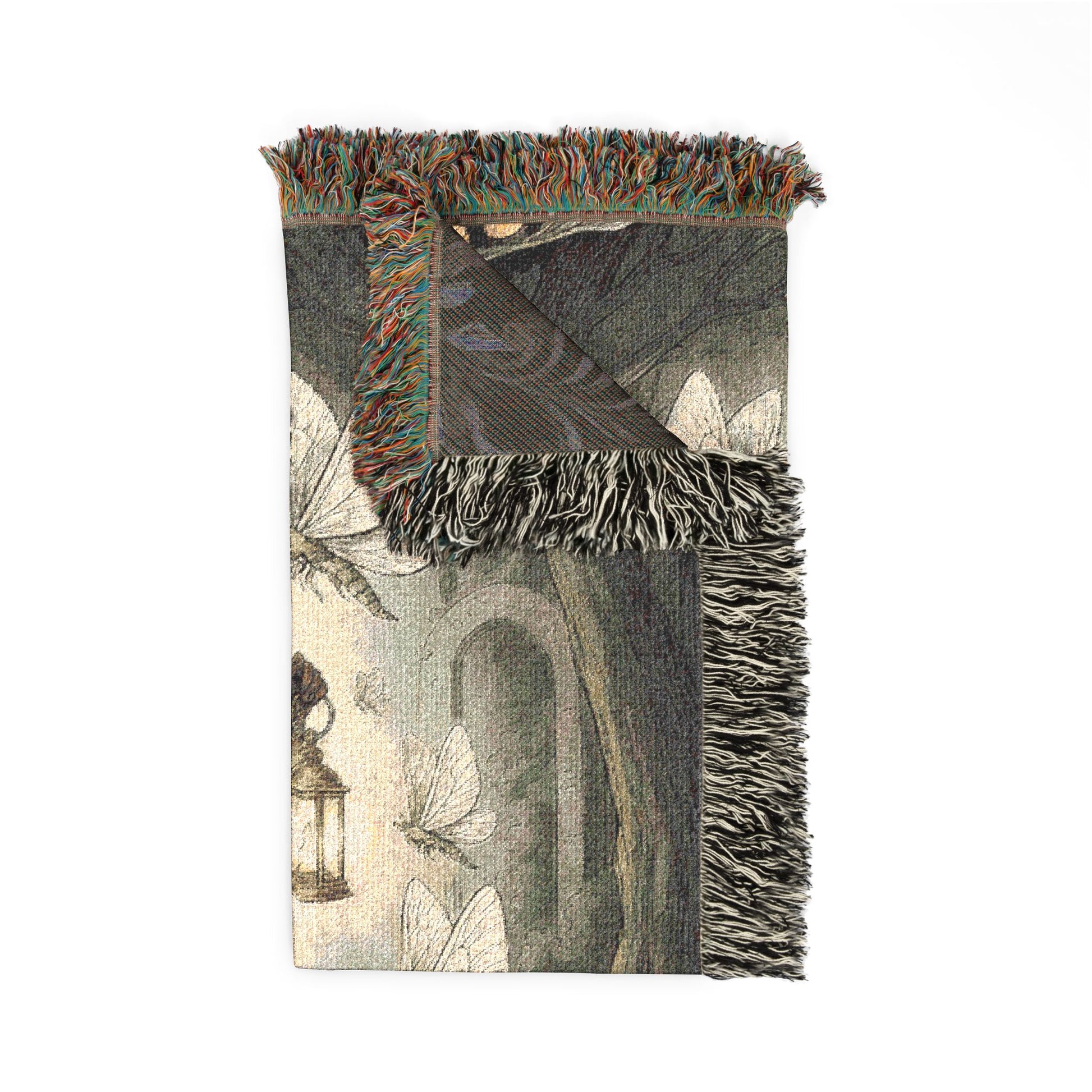 Decorative throw blanket with fringe on a white background