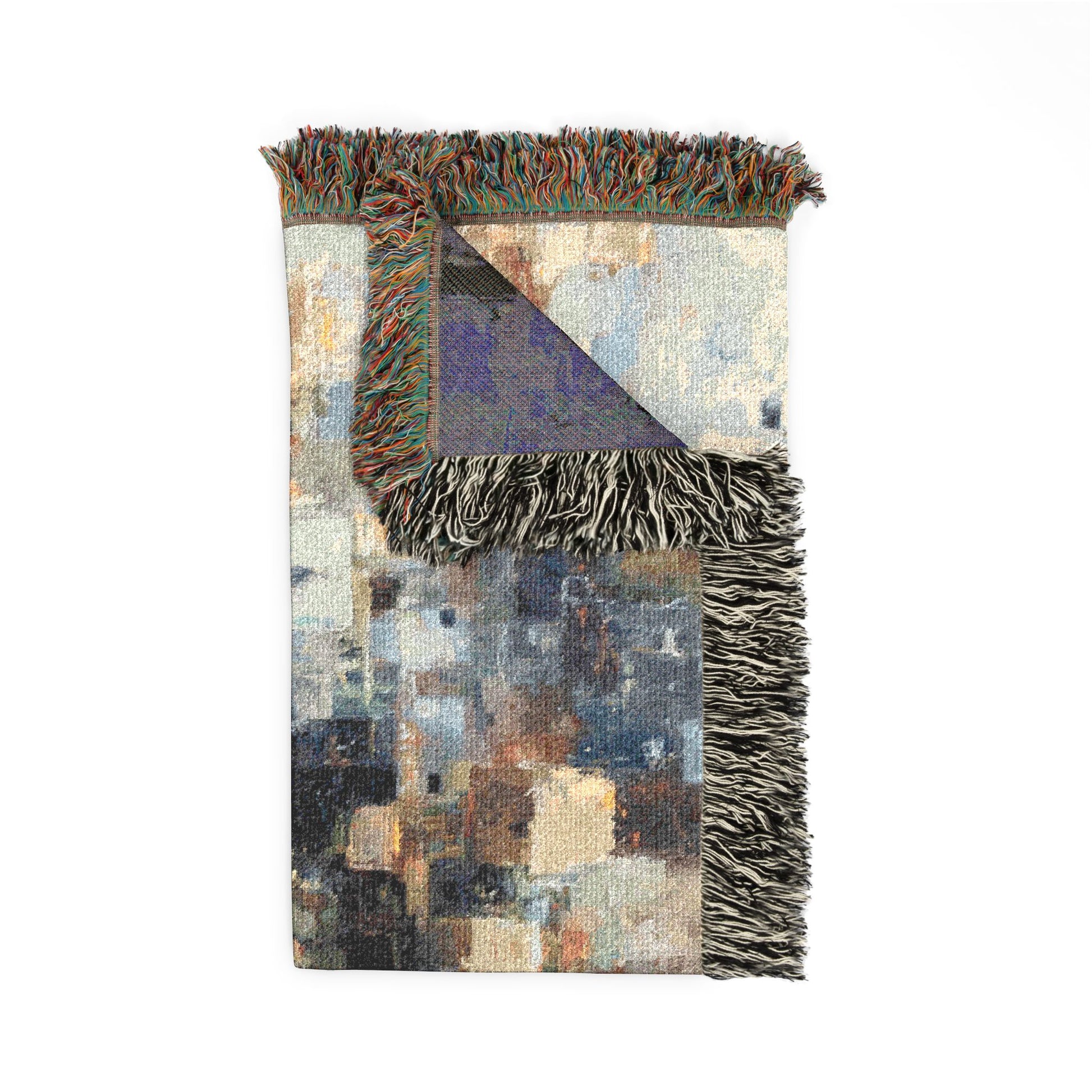 Multicolored blanket with fringe on a white background