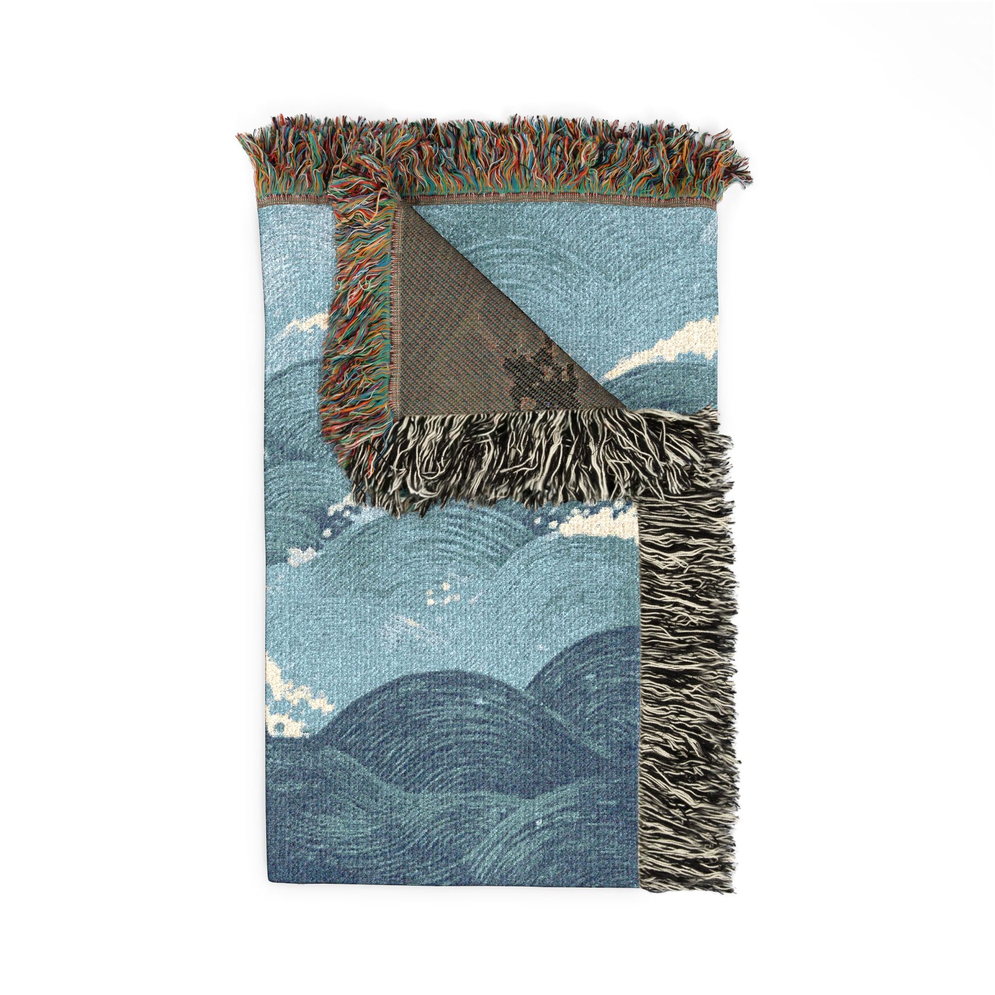 Woven blanket with a landscape design on a white background