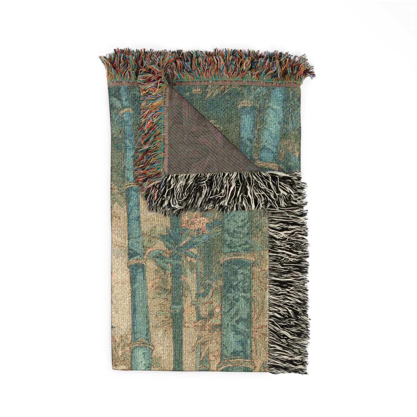 Woven blanket with intricate patterns and fringes on a white background