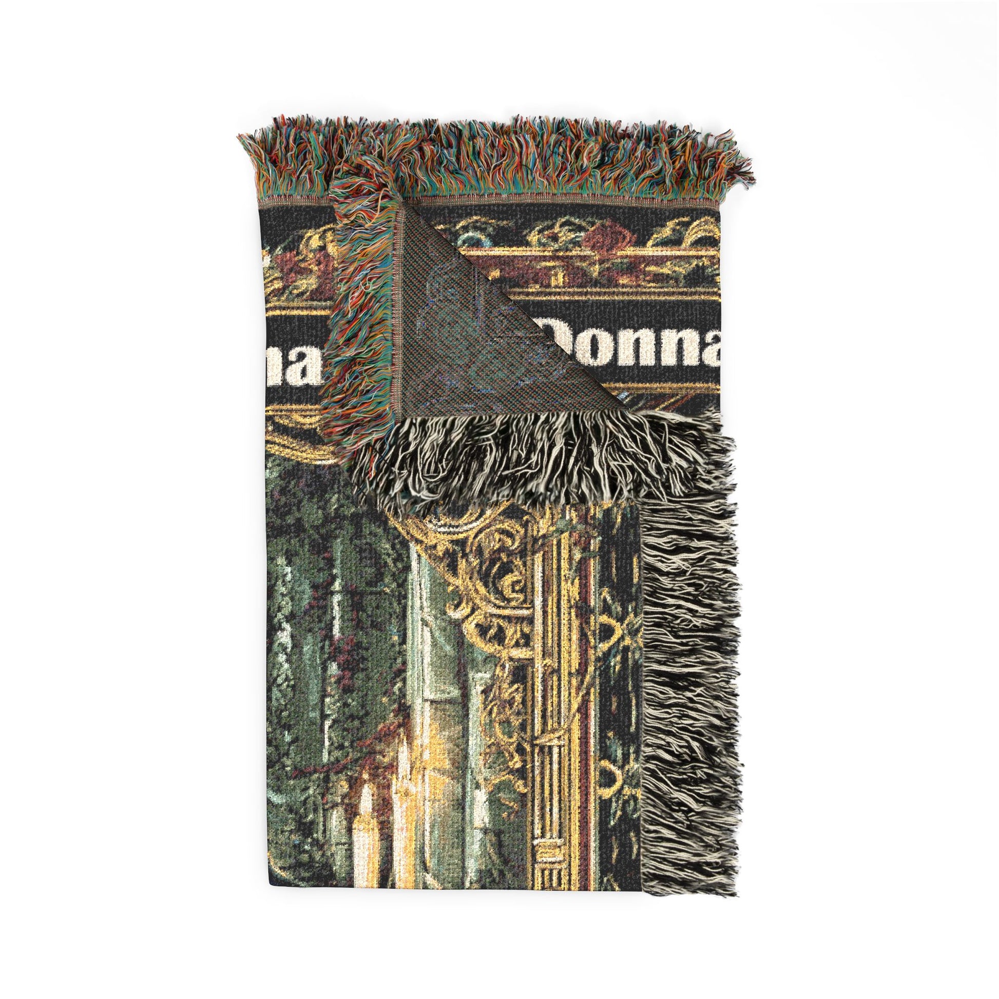 Decorative throw blanket with fringe on a white background