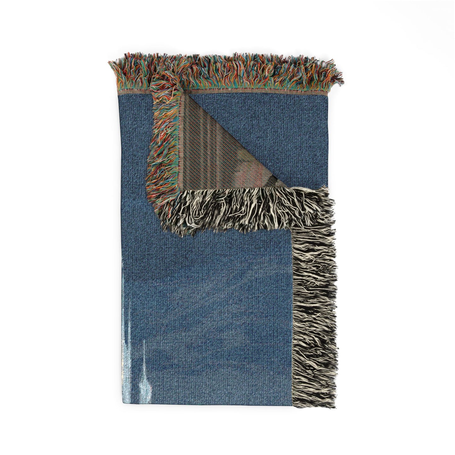 Blue woven blanket with fringed edges on a white background