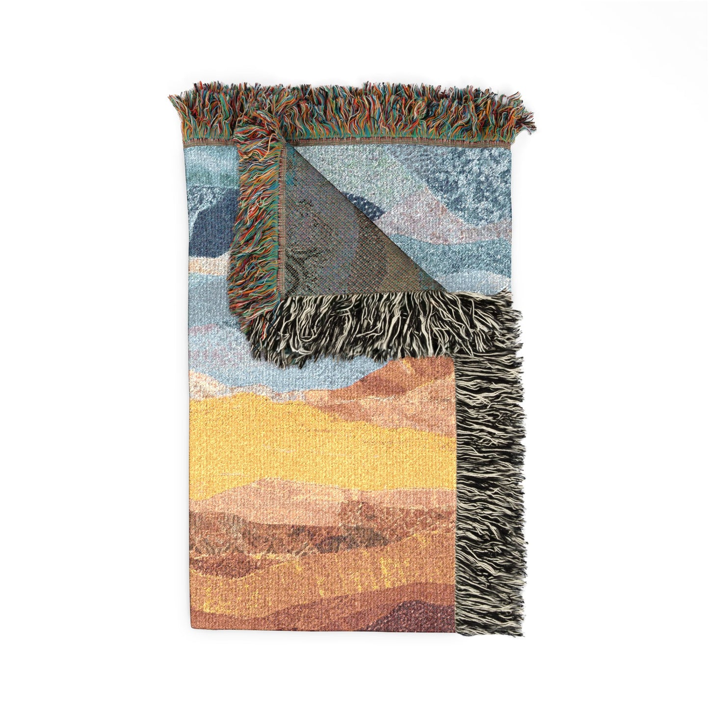 Woven blanket with colorful landscape design on a white background