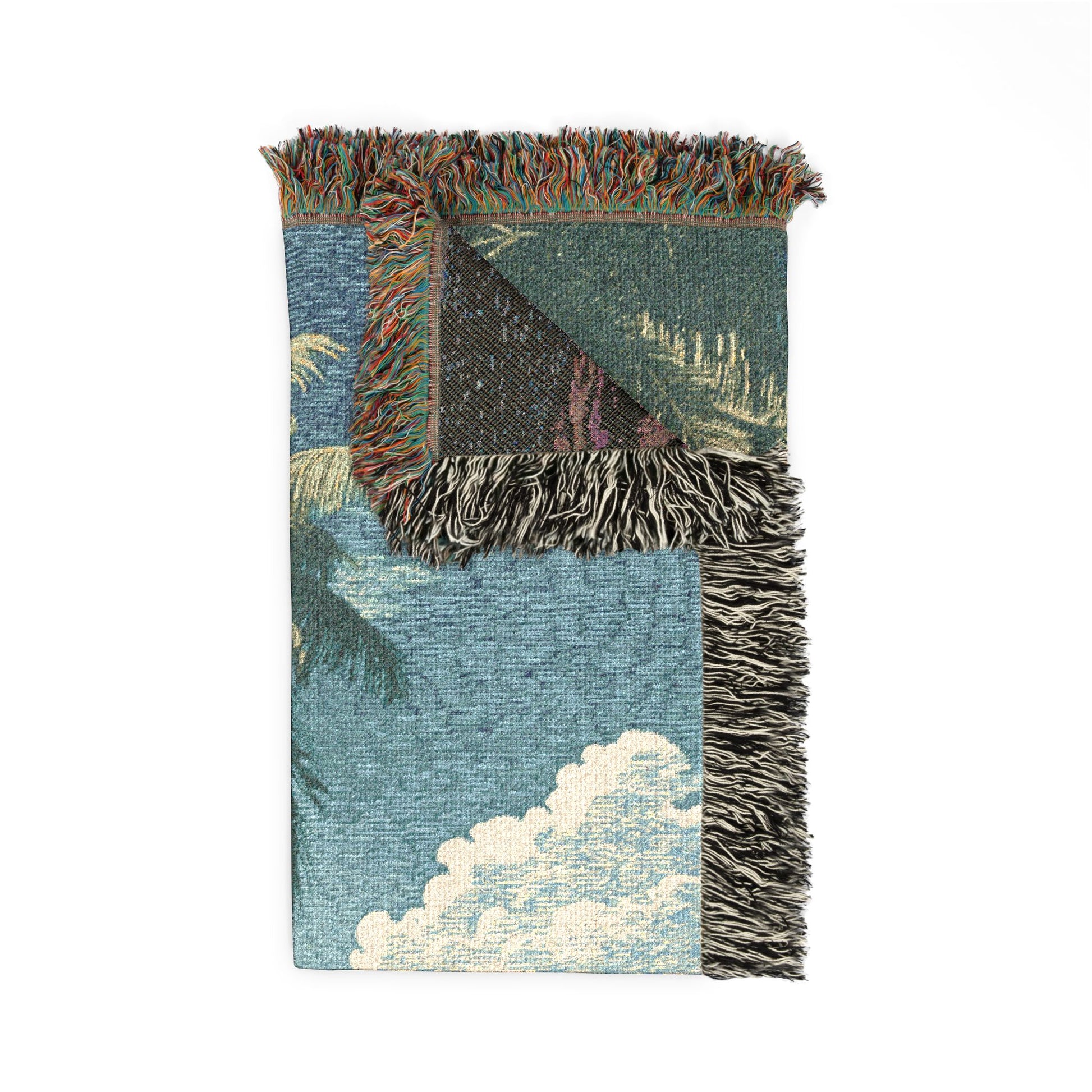 blanket with a pattern of clouds and palm trees on a white background