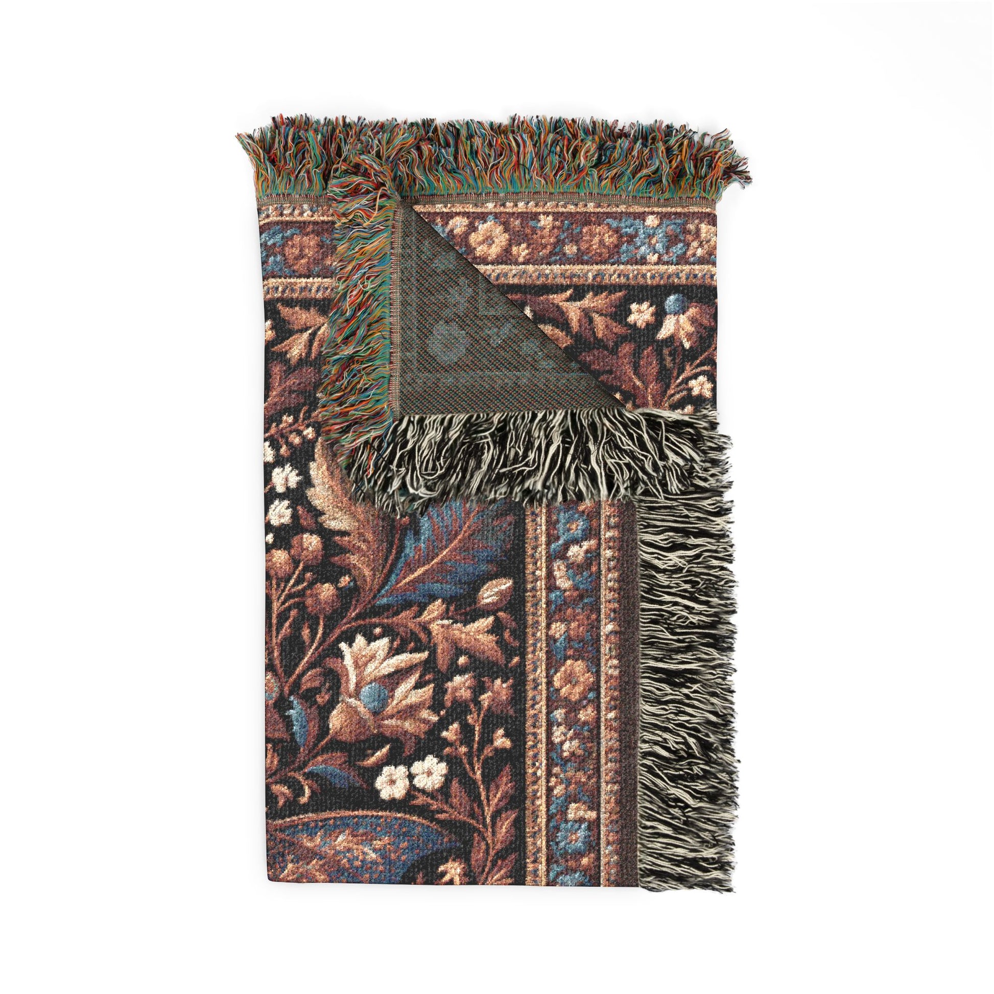 A rectangular woven throw blanket with fringed edges, featuring an intricate floral and botanical pattern in dark brown, blue, beige, and green tones, shown on a plain white background.
