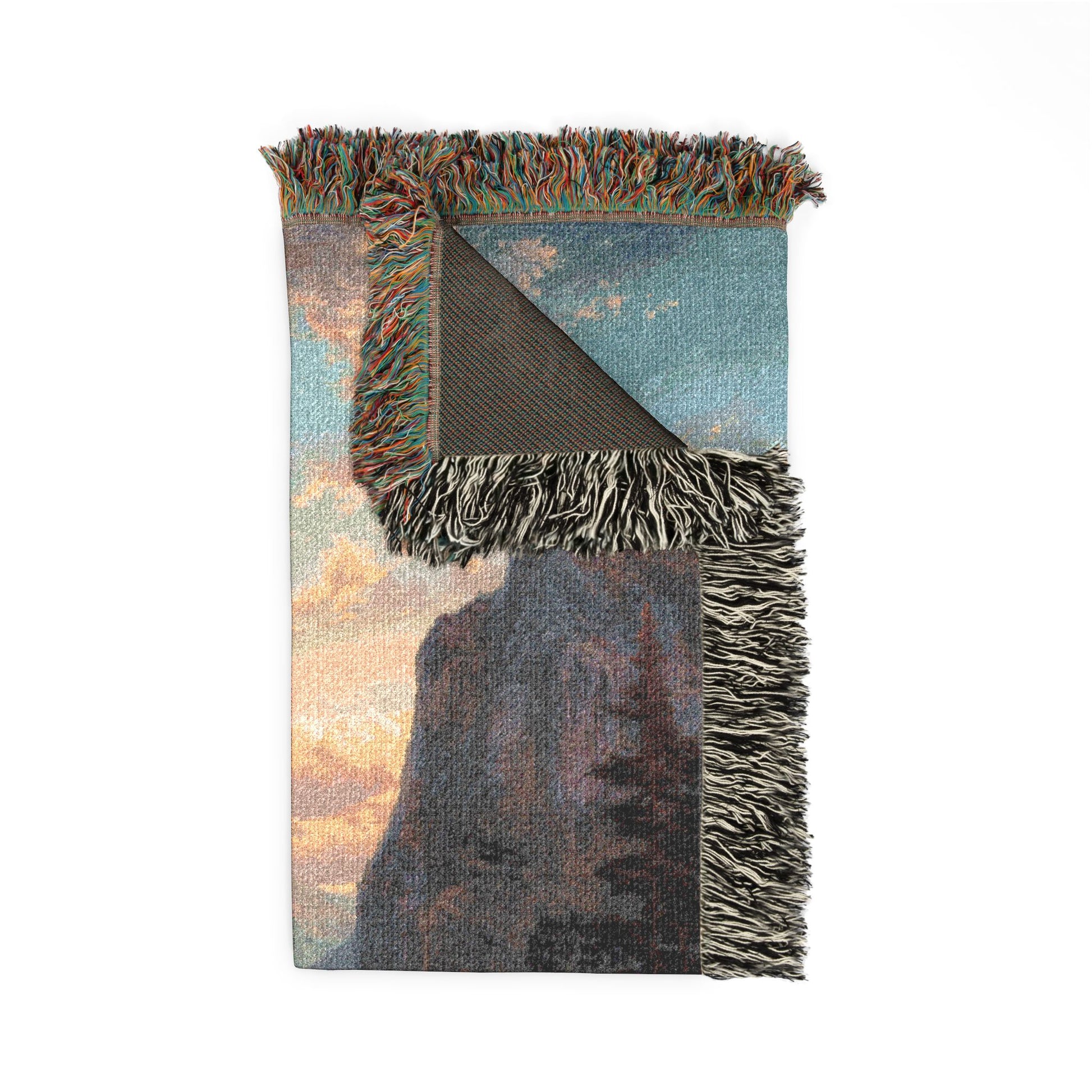Woven blanket with scenic design on a white background