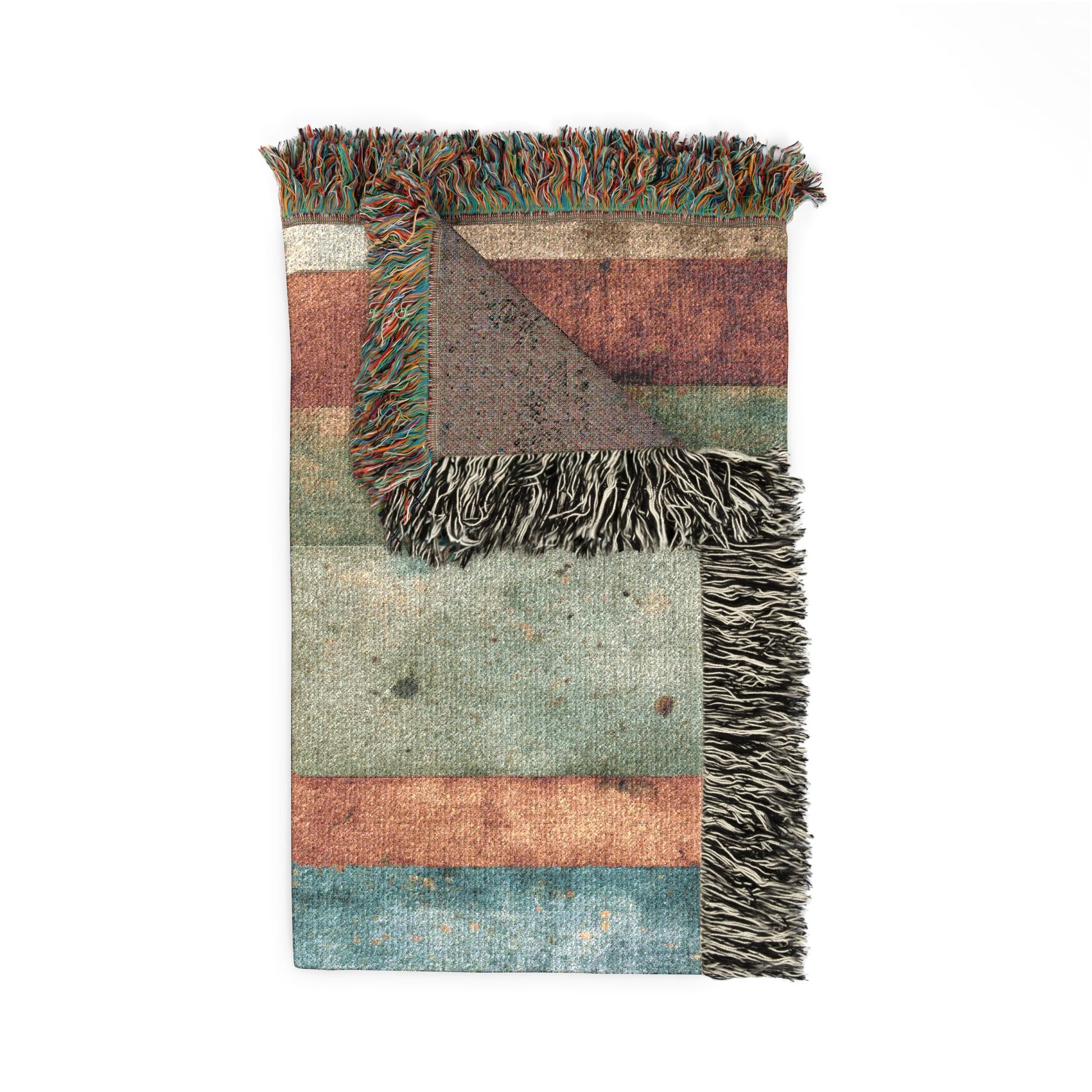Multicolored woven blanket with fringes on a white background