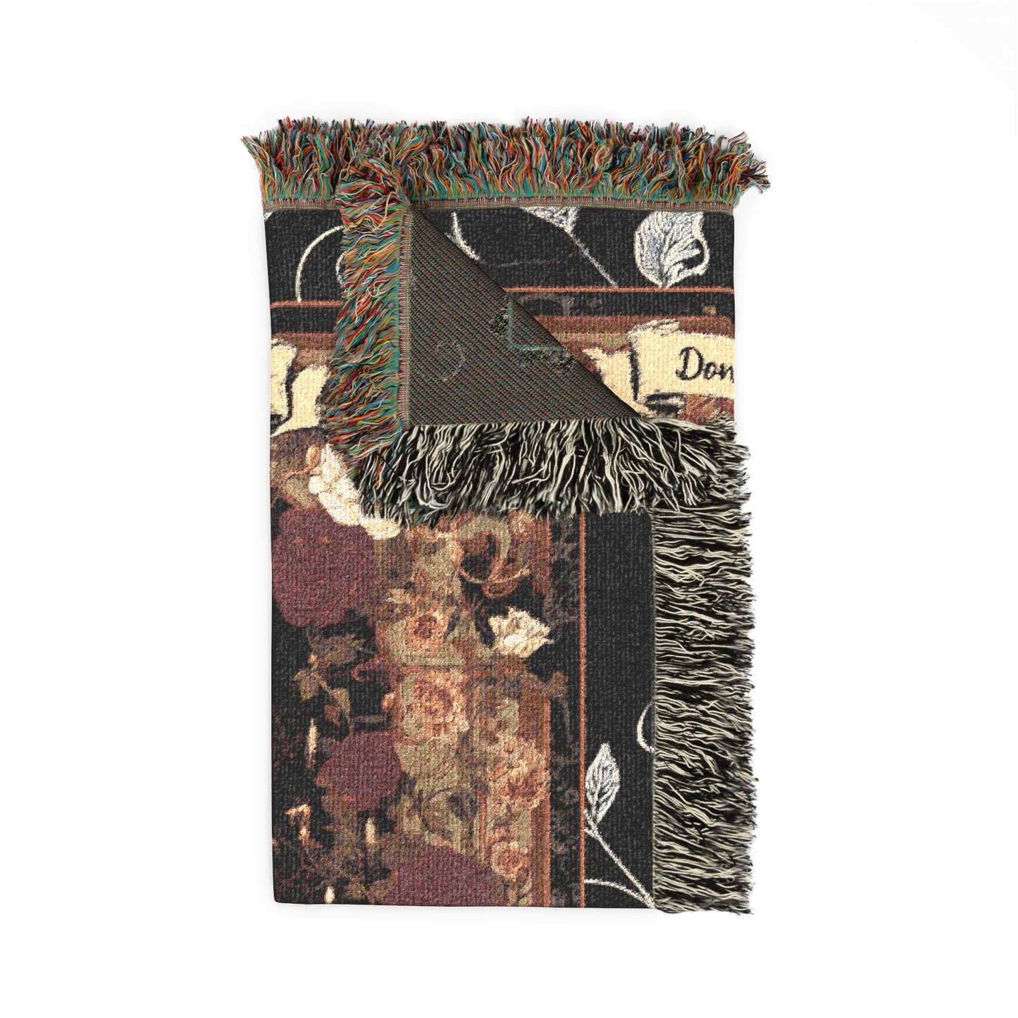 Decorative throw blanket with floral pattern and fringes on a white background