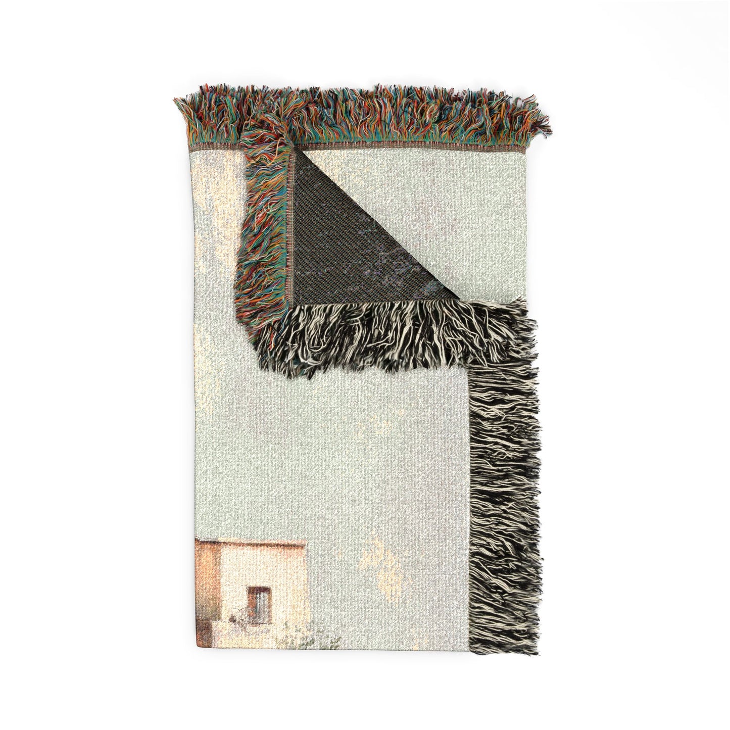 Blanket with fringed edge and a scenic print on a white background