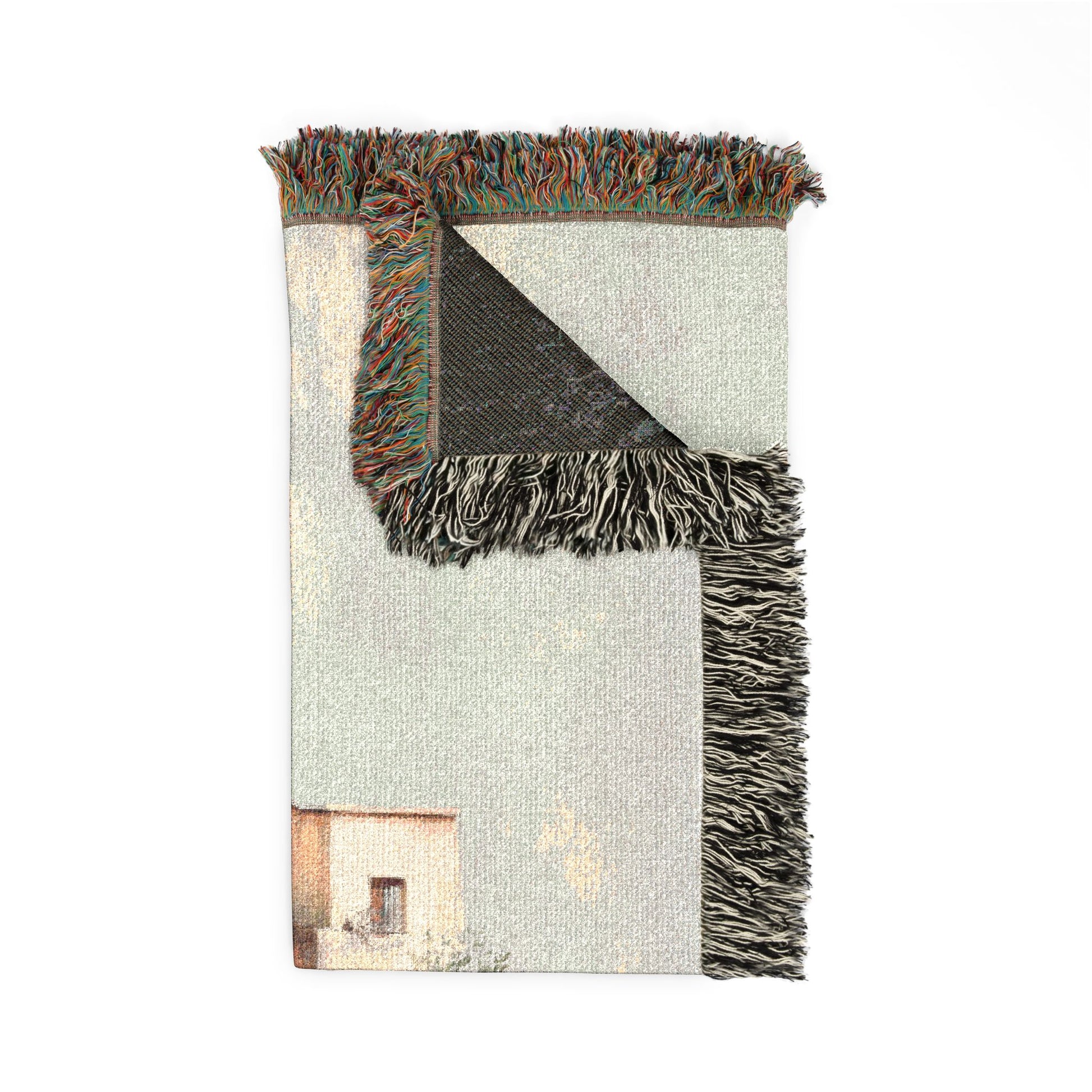 Blanket with fringed edge and a scenic print on a white background