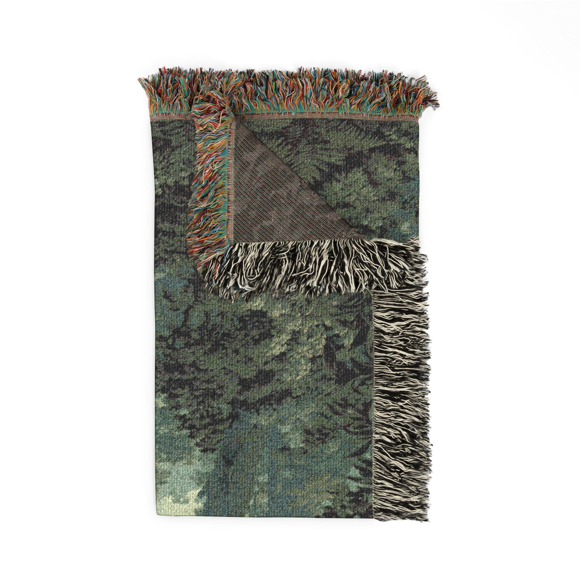 A rectangular woven throw blanket with a forest camouflage pattern in shades of green, gray, and black, featuring fringed edges and a reverse side with a different pattern, shown on a plain white background.