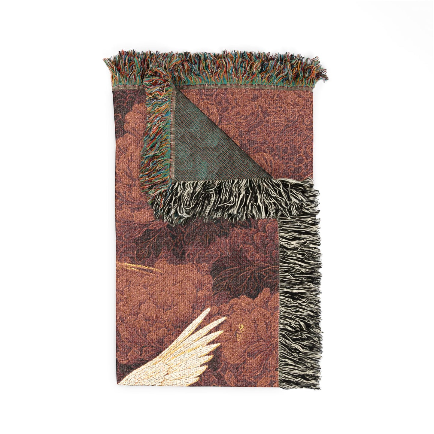 Floral-patterned blanket with fringes on a white background