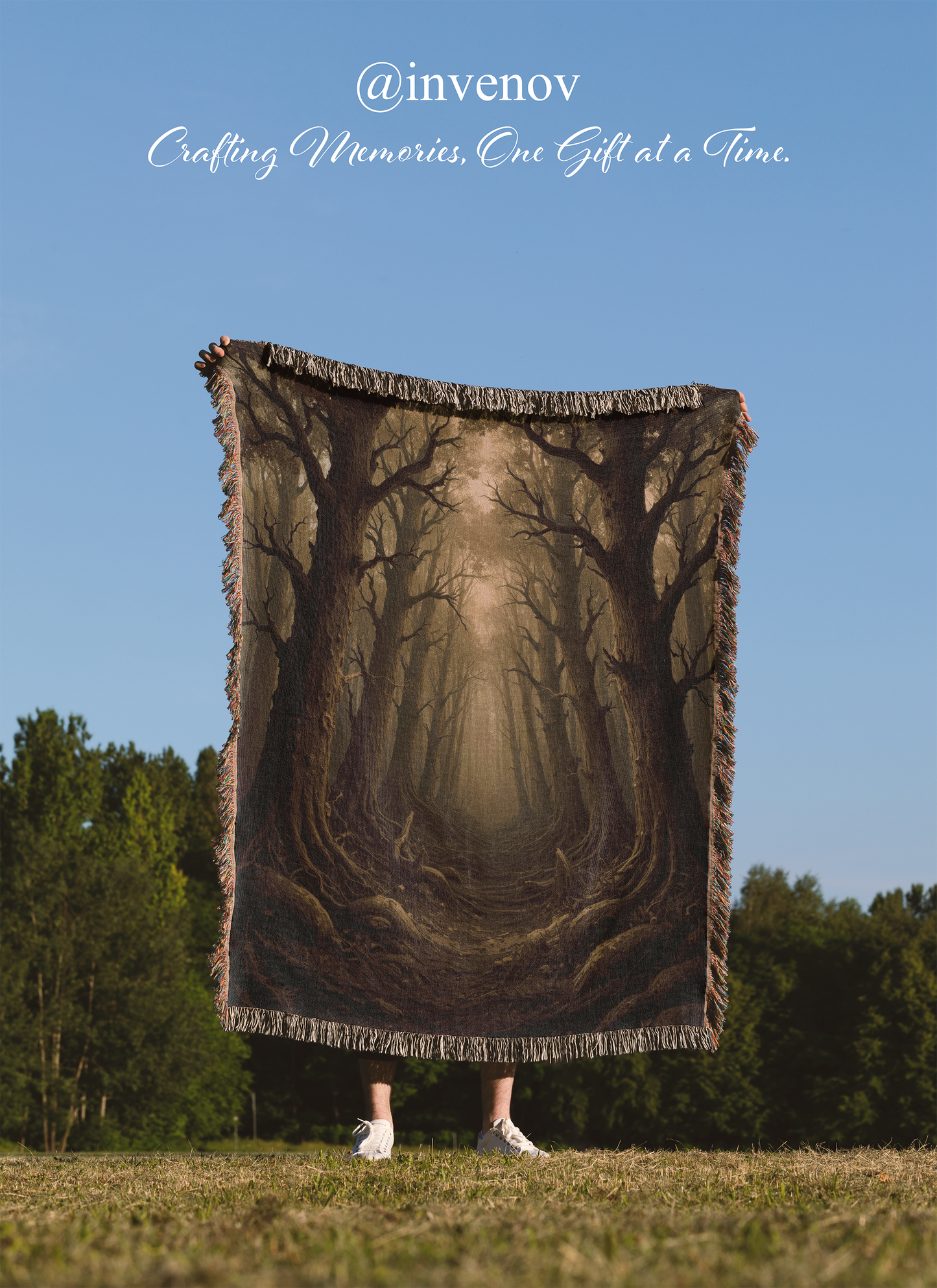 Person holding a forest-themed blanket outdoors