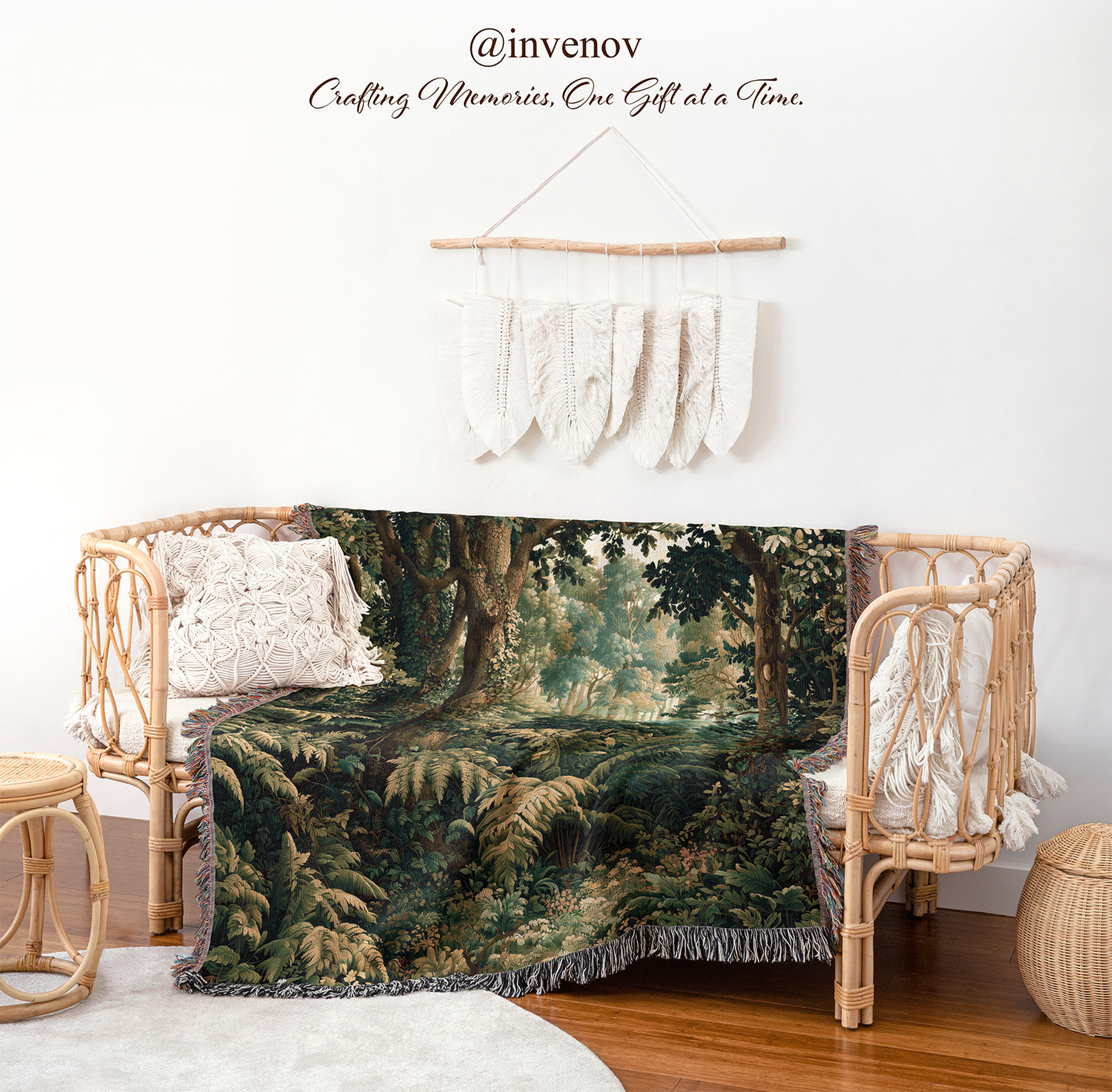 A forest-themed throw blanket draped over a rattan daybed in a styled room setting, with a macrame wall hanging and decorative pillows above it.