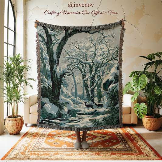 A large fringed tapestry or throw blanket featuring a snowy forest scene with deer, held up in a styled room with plants, chairs, and a rug.