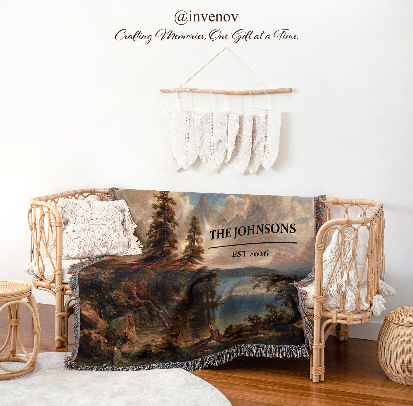 A personalized landscape throw blanket draped over a rattan daybed in a styled room setting. The blanket features a classical painting of a forest lake 