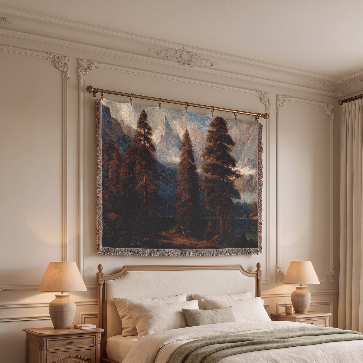A large woven wall tapestry featuring a classical landscape painting of pine trees and mountains, hanging on a gold rod above a bed in a classic cream-colored bedroom.
