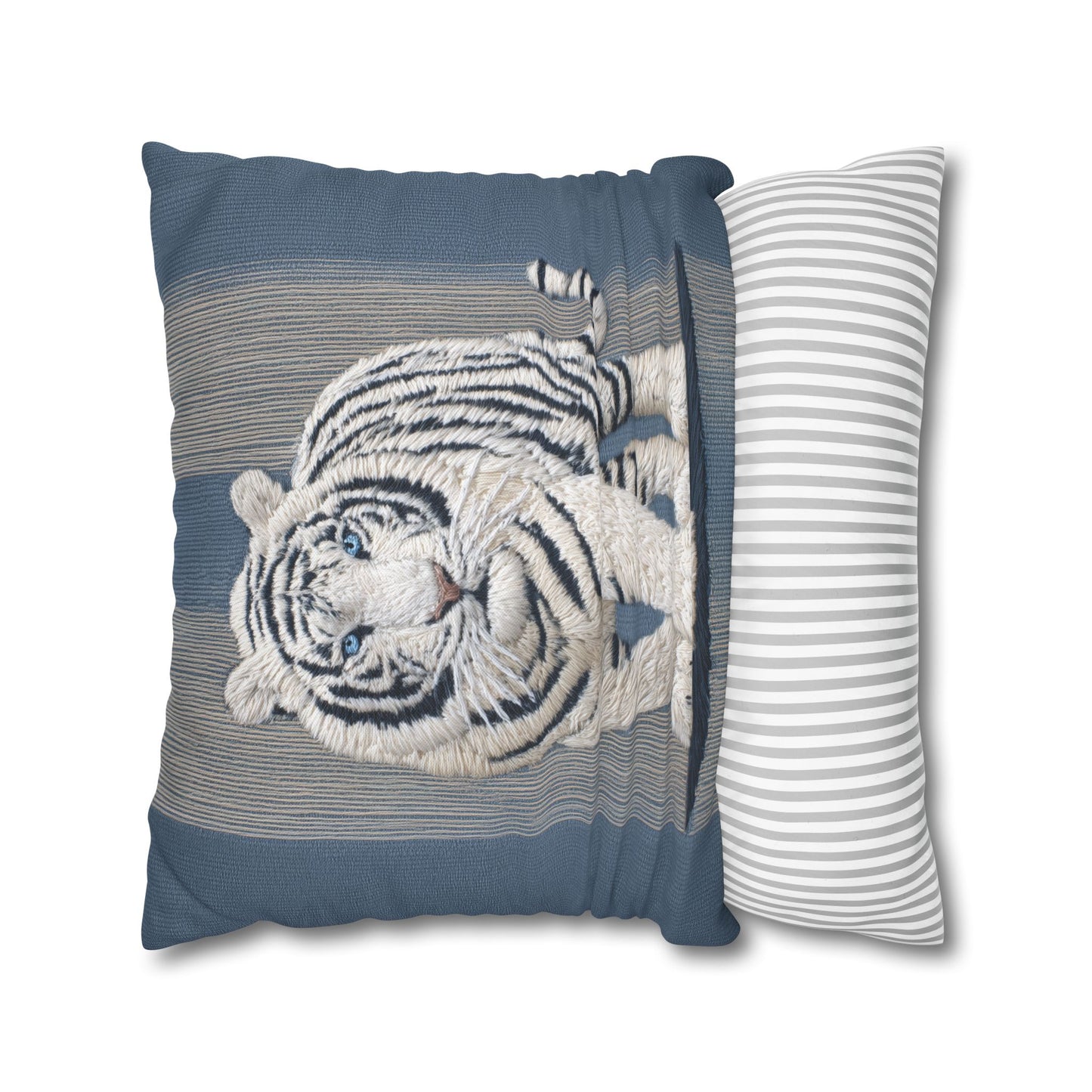 Decorative pillow with embroidered tiger design on a blue background