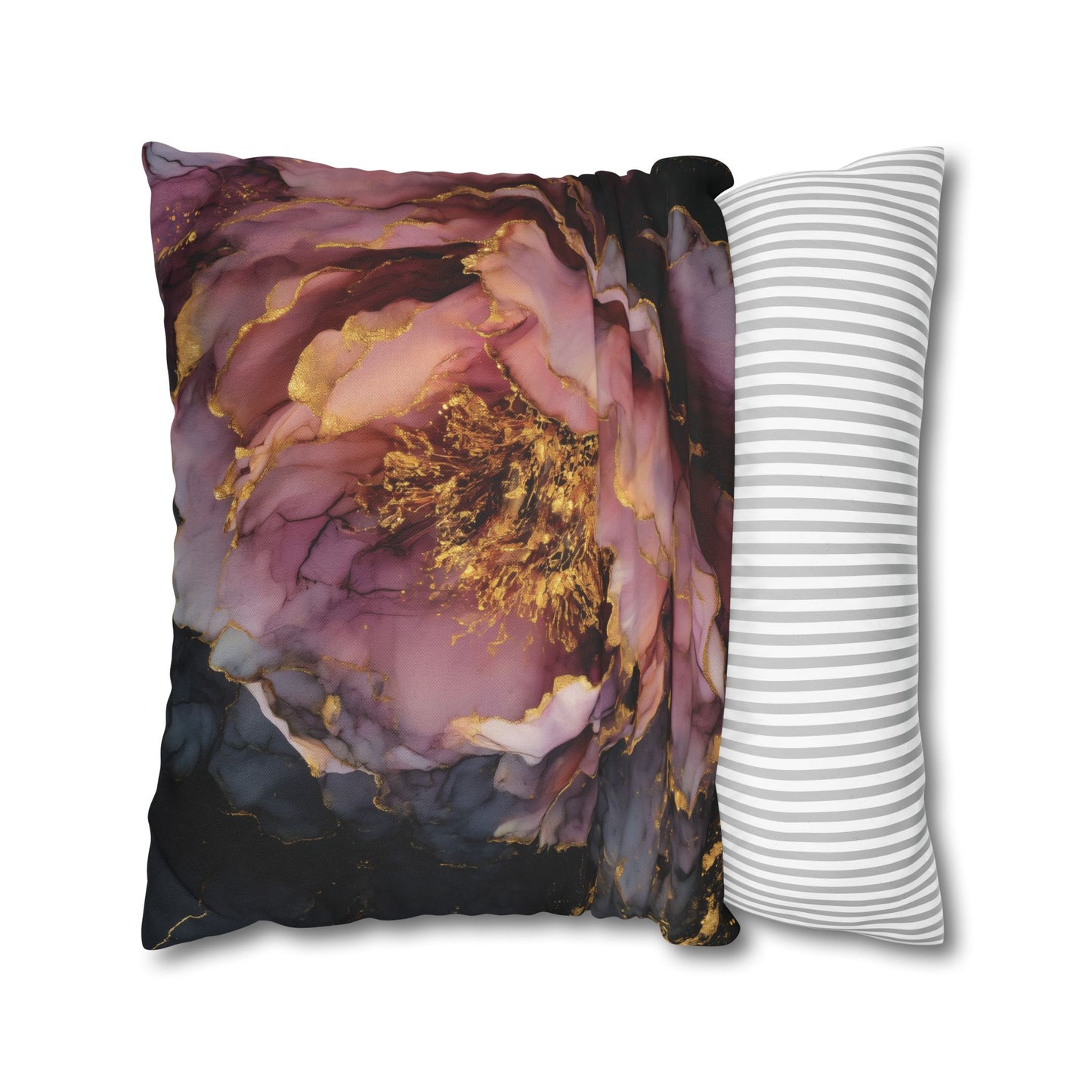 A decorative throw pillow featuring a large purple and gold abstract flower print on one side and a white side with thin gray stripes, shown on a plain white background.
