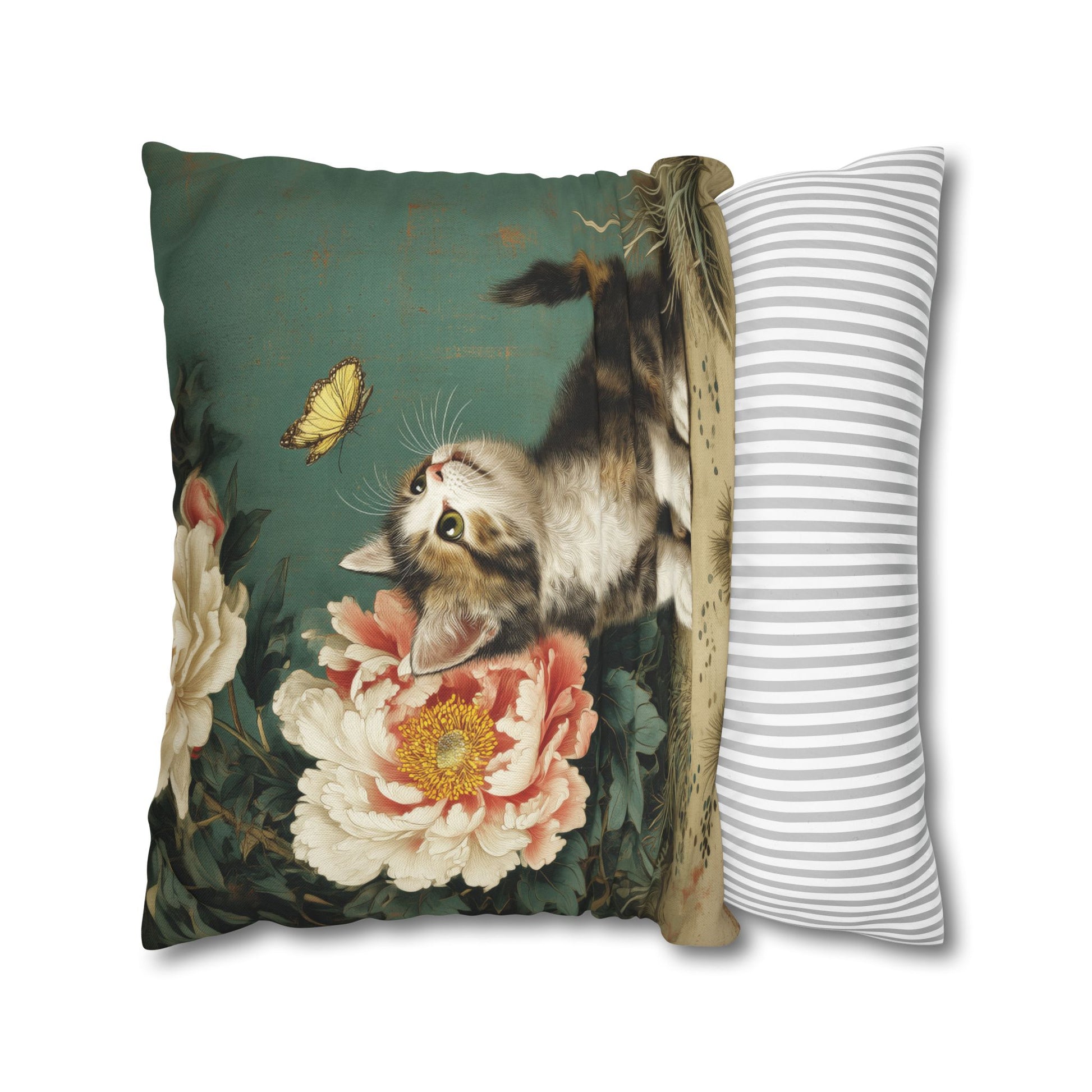 Decorative pillow with a cat and butterfly design next to a striped pillow on a white background