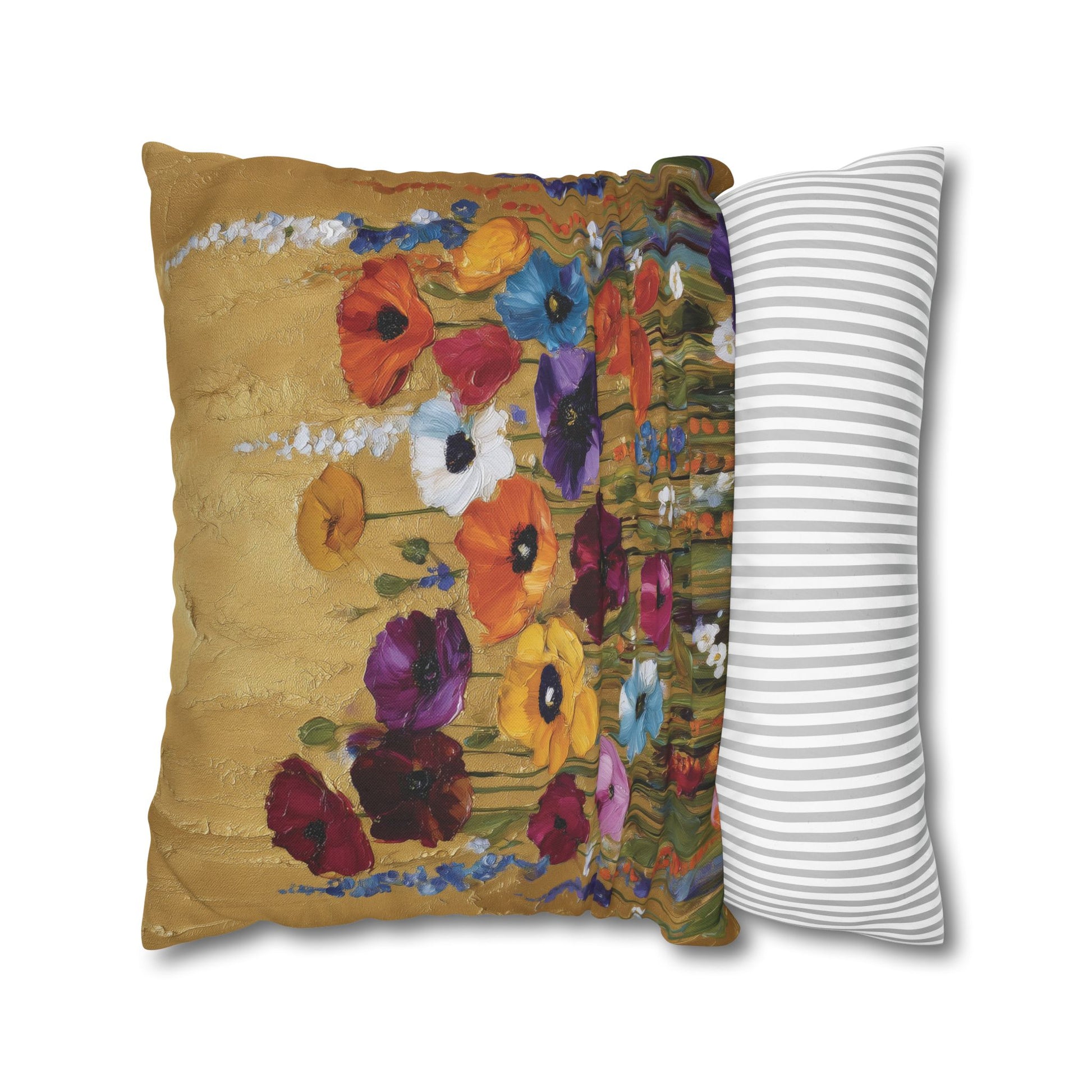 Decorative pillow with floral design next to a striped pillow on a white background